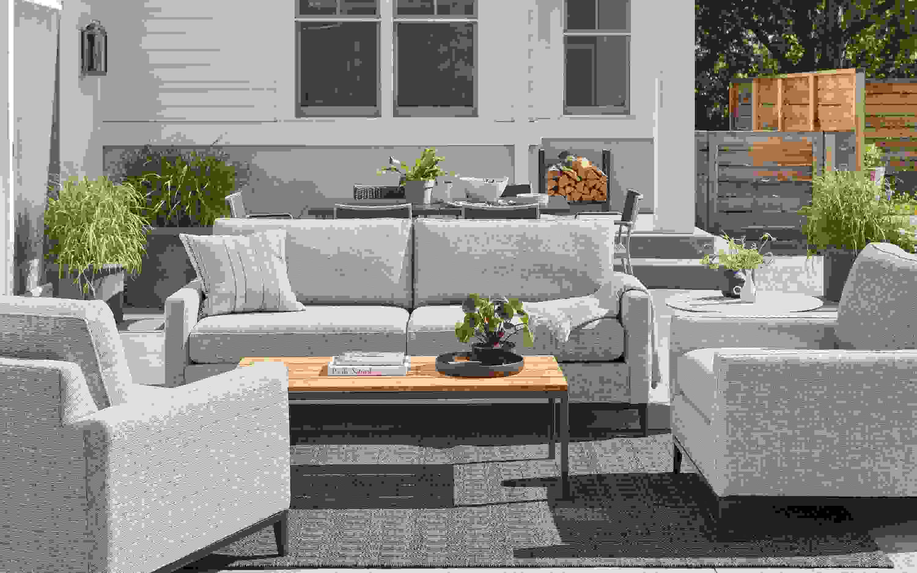 Tomas outdoor sofa and two chairs in Phipps taupe fabric with Parsons 48-wide coffee table in graphite with Bamboo top.