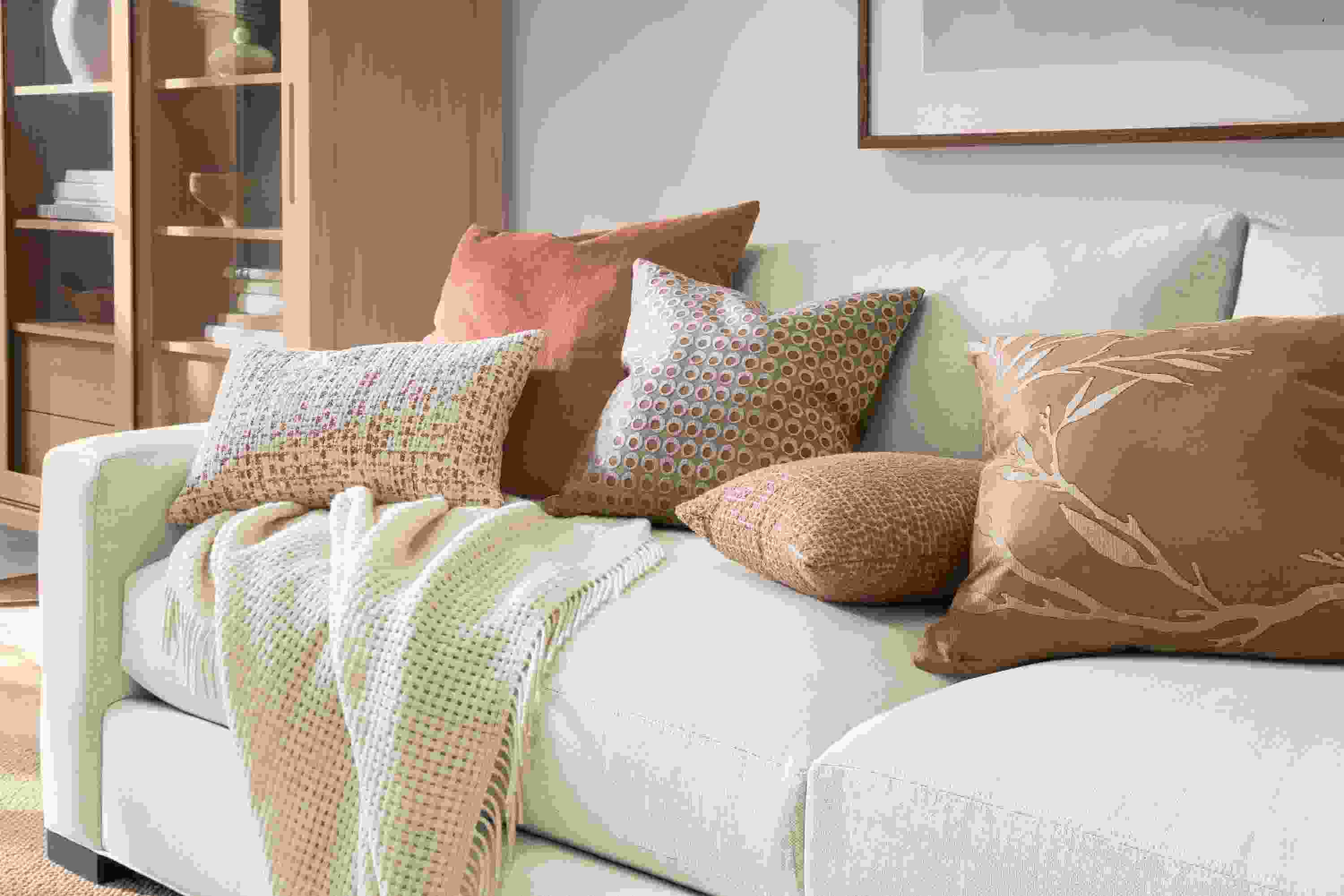 Group of pillows including Tromso, Windsor, Dot, Koko and Liana on a Metro sofa in Sumner Ivory.