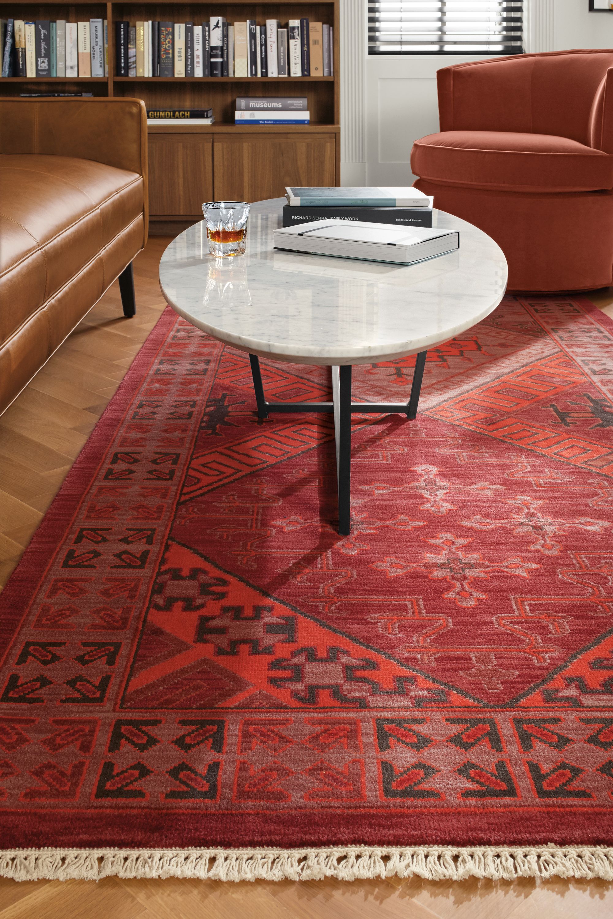 room setting including tulsara rug, goodwin sofa, otis swivel chair, soto coffee table, keaton bookcase.