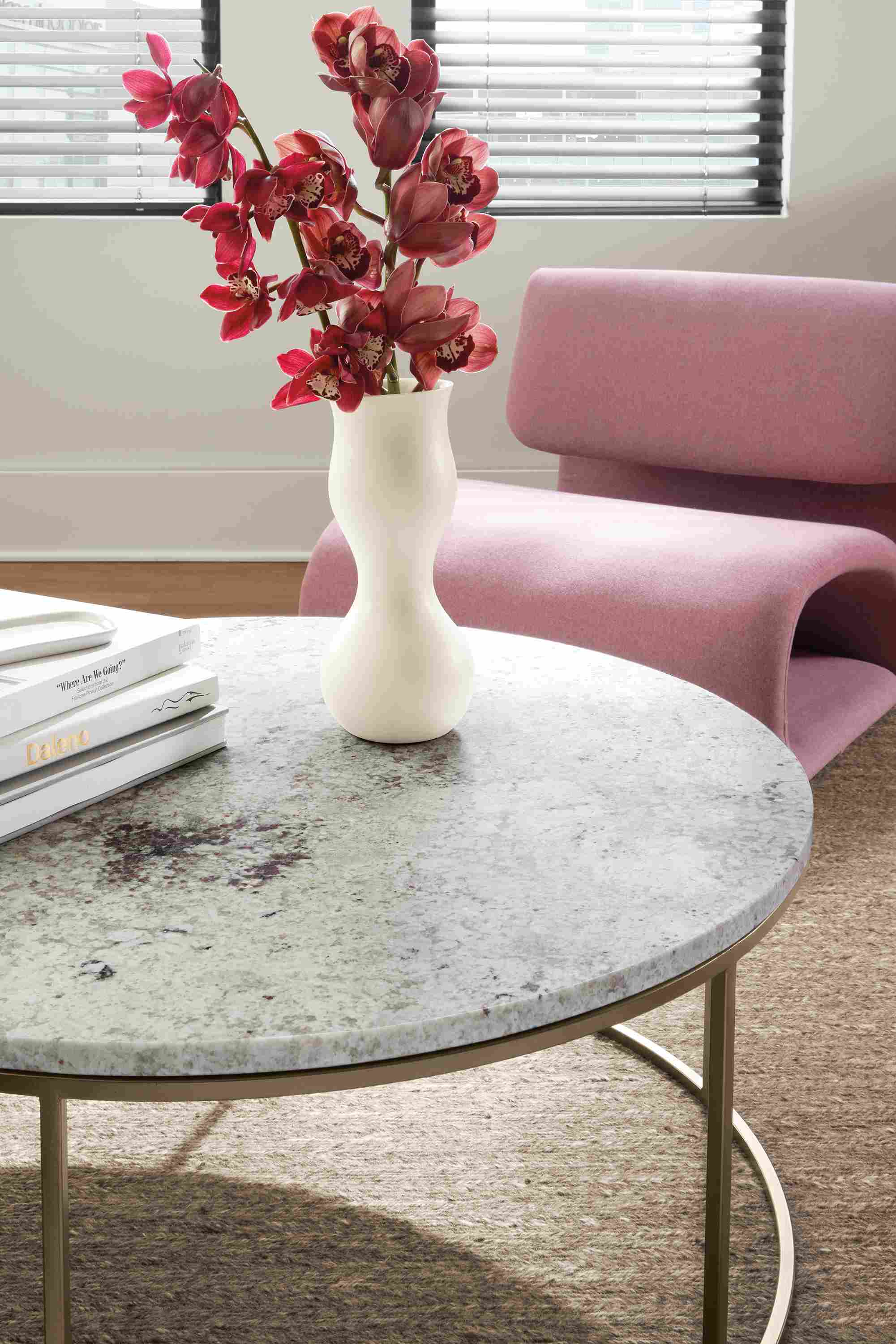 detail of Eva vase on Tyne coffee table beside Eve chair in mauve.