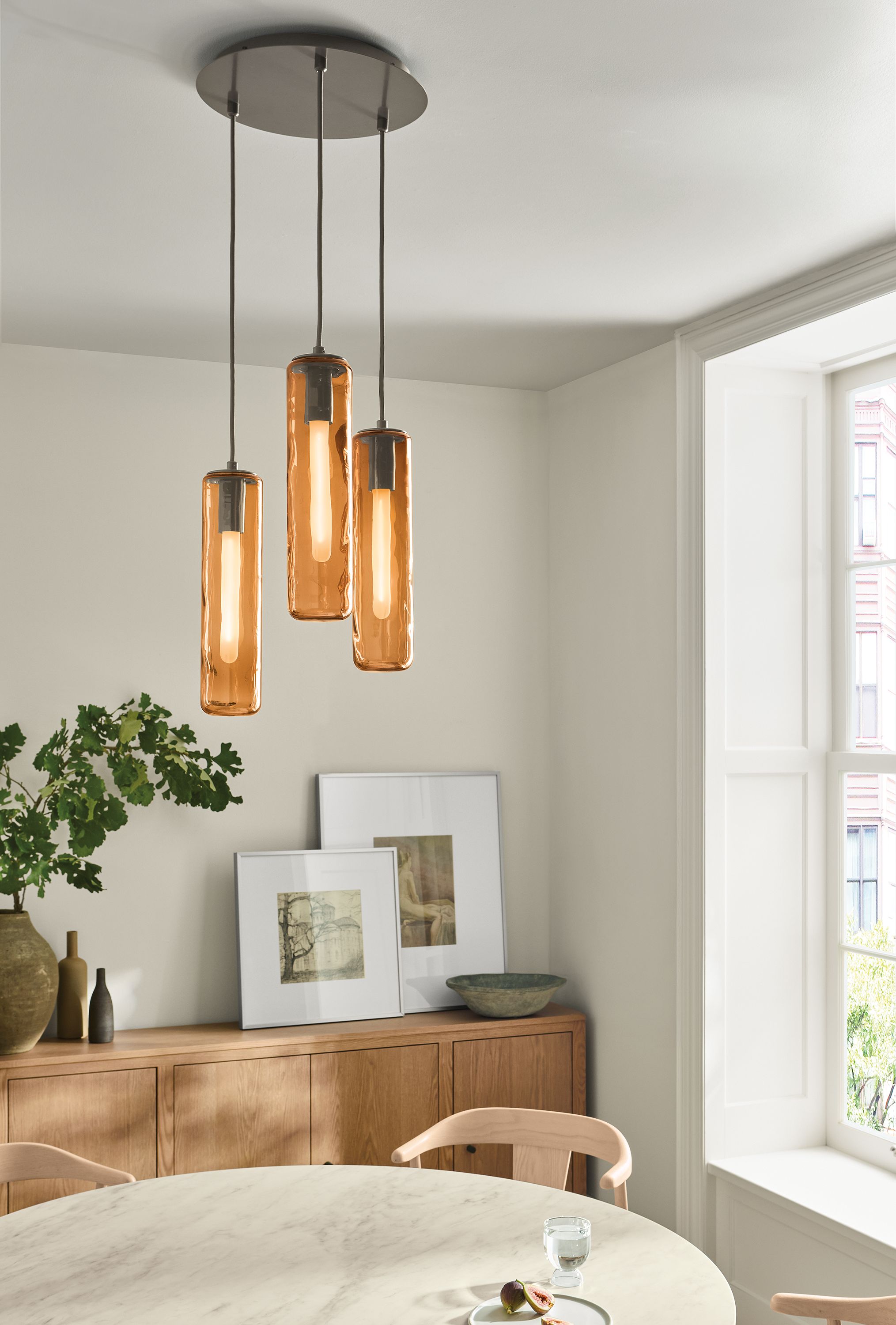 Dining room with Ursa 3 pendant light in chestnut glass with mineral ceiling plate.