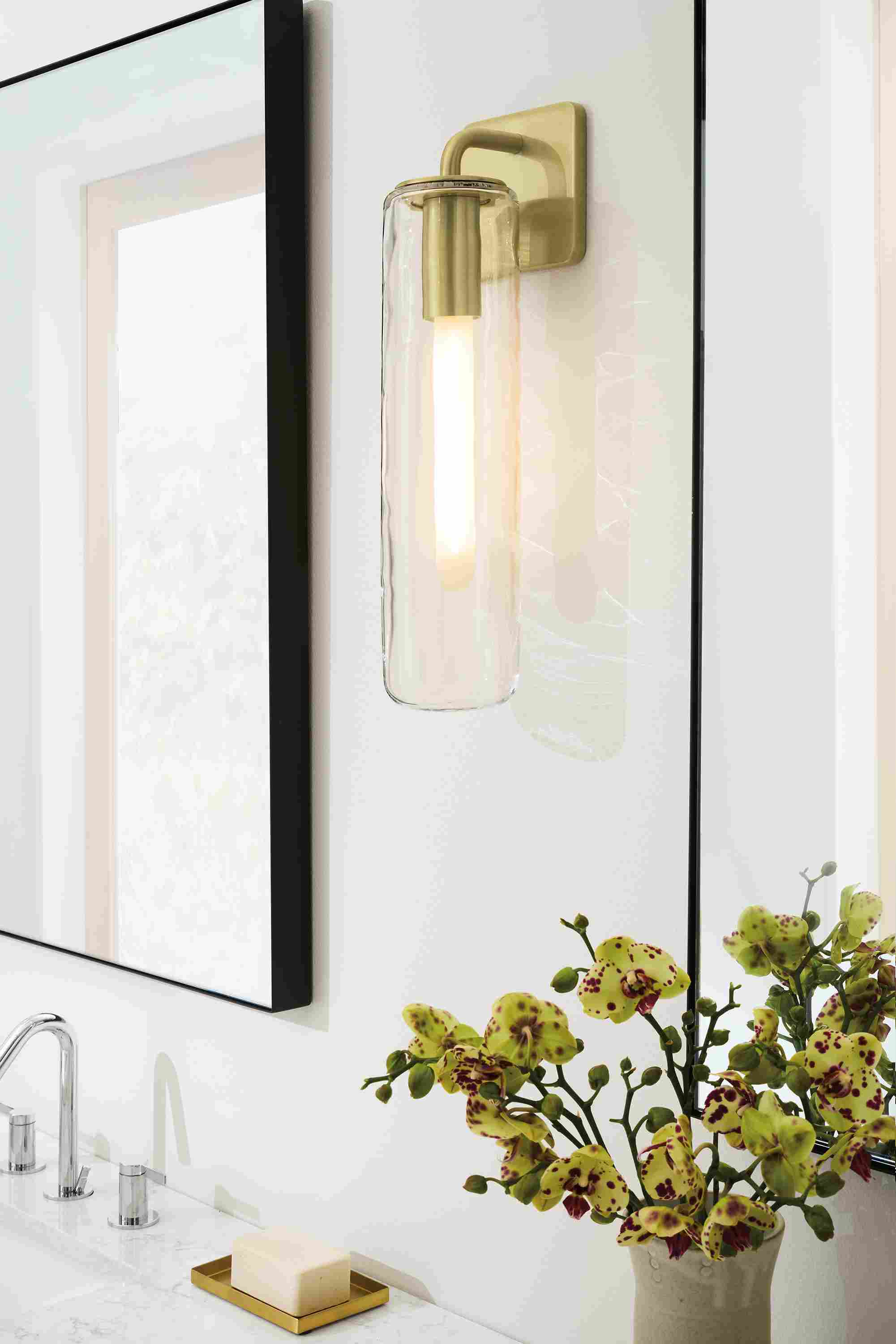 Bathroom with detail of Ursa 18.5-high wall sconce in clear glass and brushed gold powdercoat and 2 infinity wall mirrors in graphite.