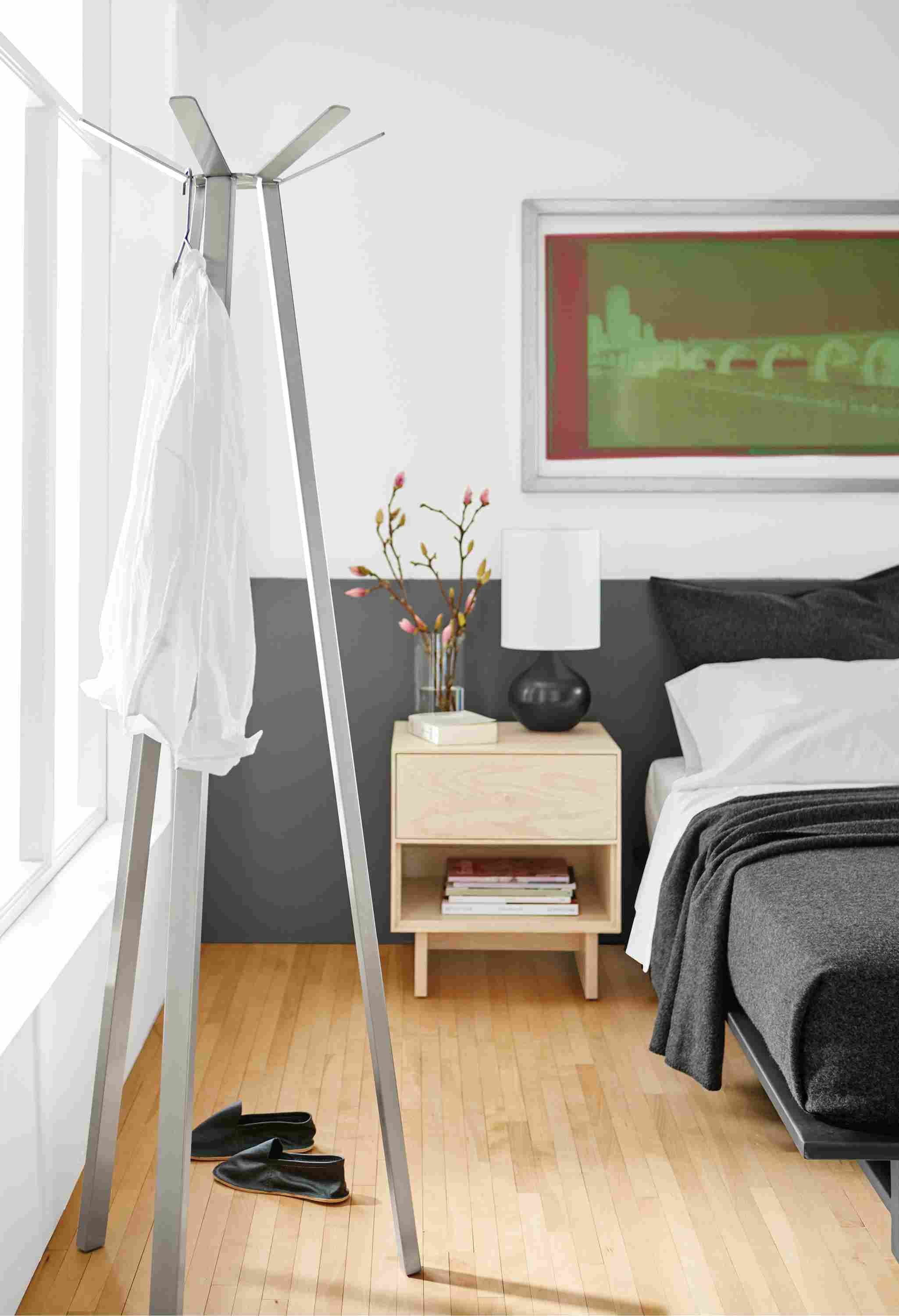 Bedroom setting with Utility 68-high 6-arm coat rack in Stainless Steel and Hudson nightstand in Sand.