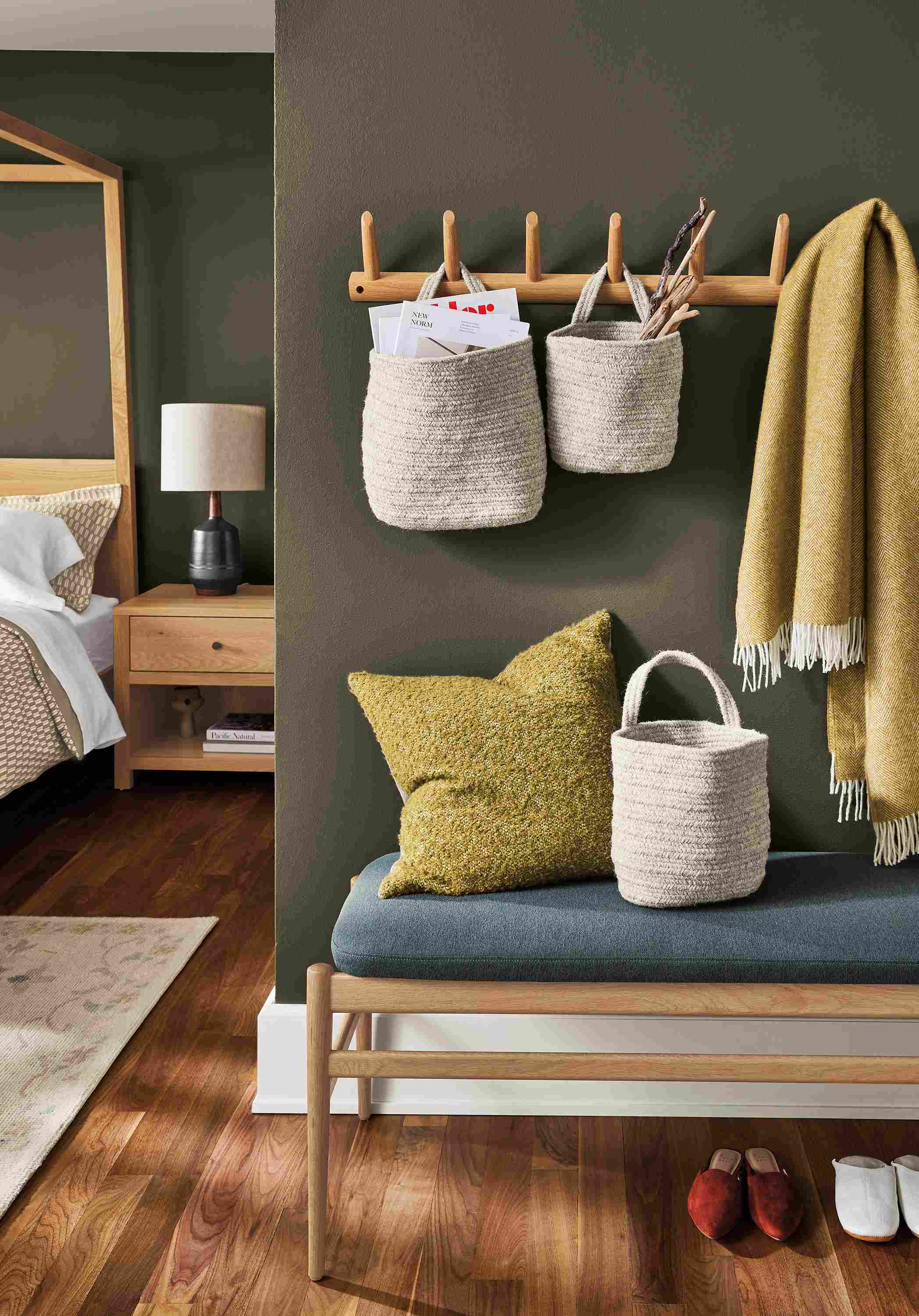 Seating area with Valet multiple wall hook in white oak with Bryer hanging baskets in natural.