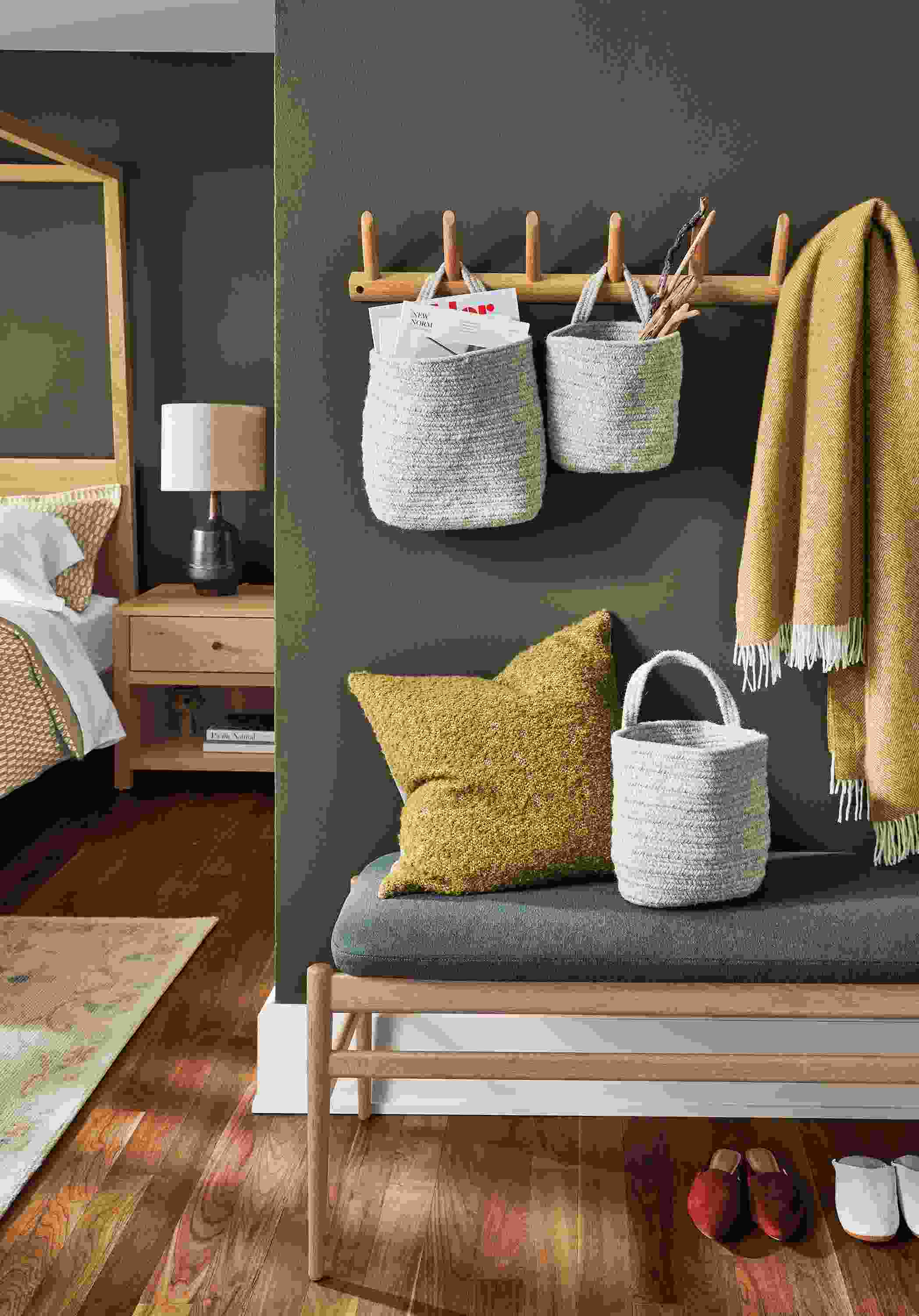 Seating area with Valet multiple wall hook in white oak with Bryer hanging baskets in natural.