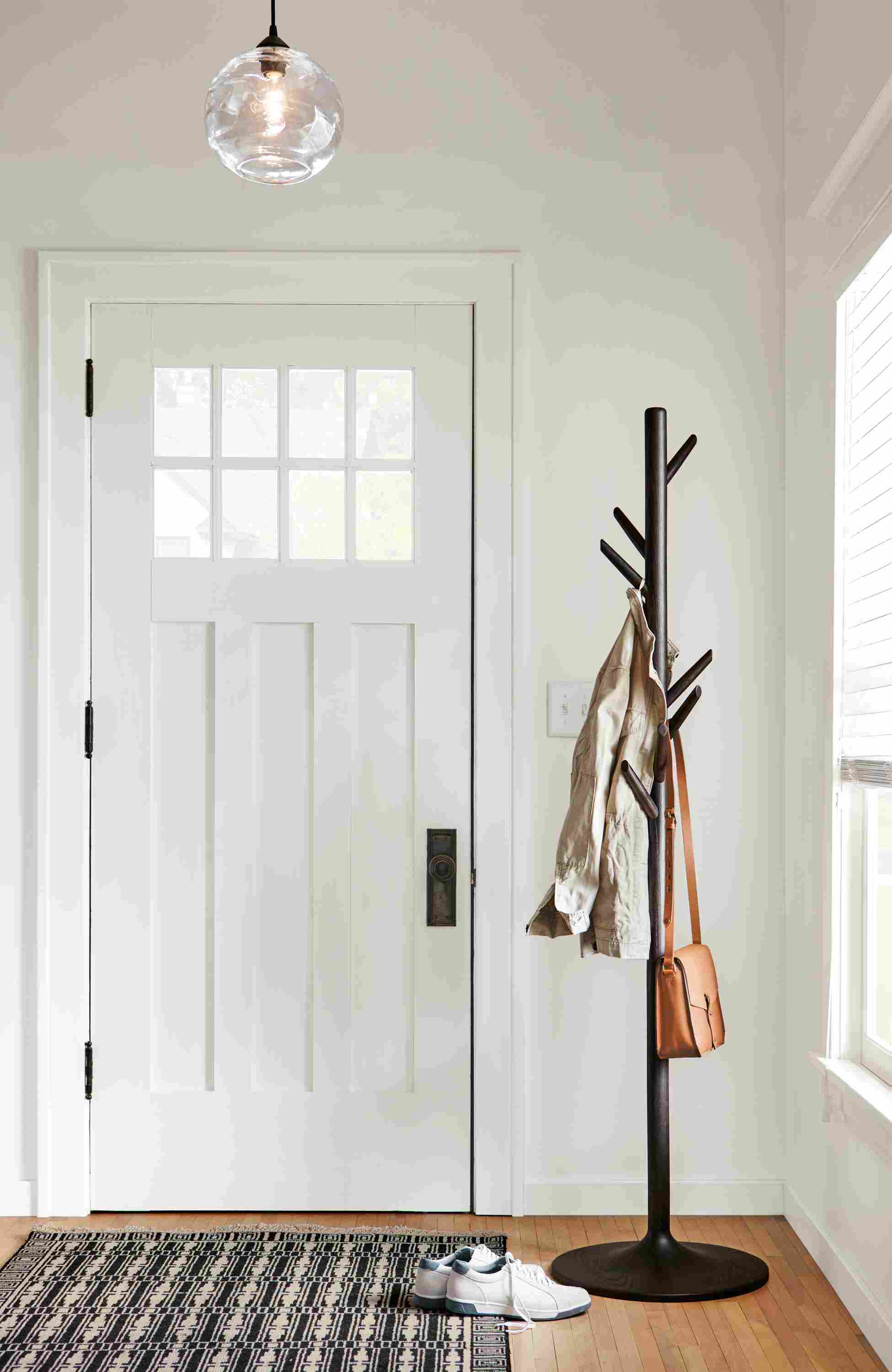 Entryway with Valet coat rack in charcoal, glow globe pendant in clear glass and Tulum rug in ebony.