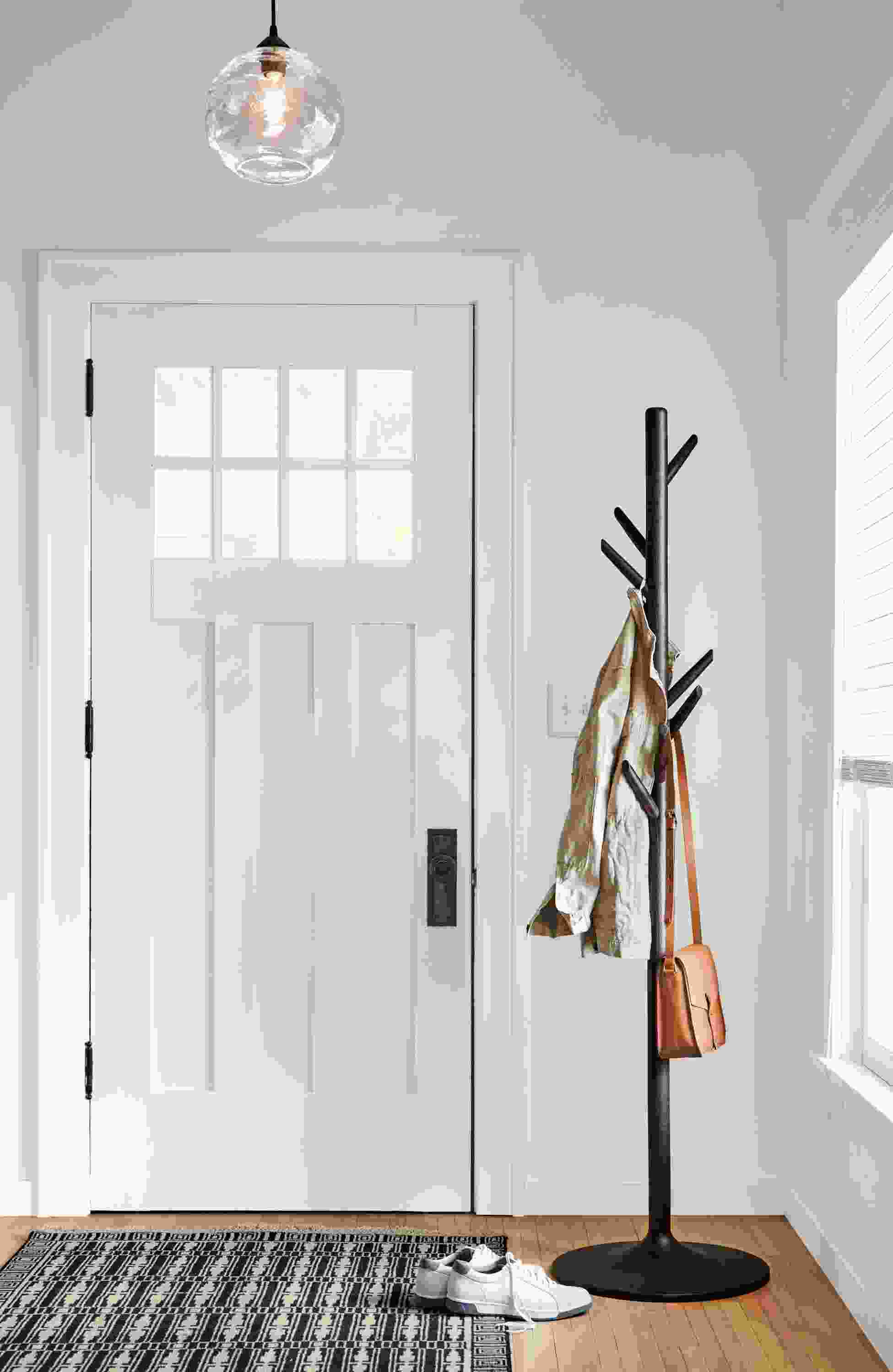 Entryway with Valet coat rack in charcoal, glow globe pendant in clear glass and Tulum rug in ebony.