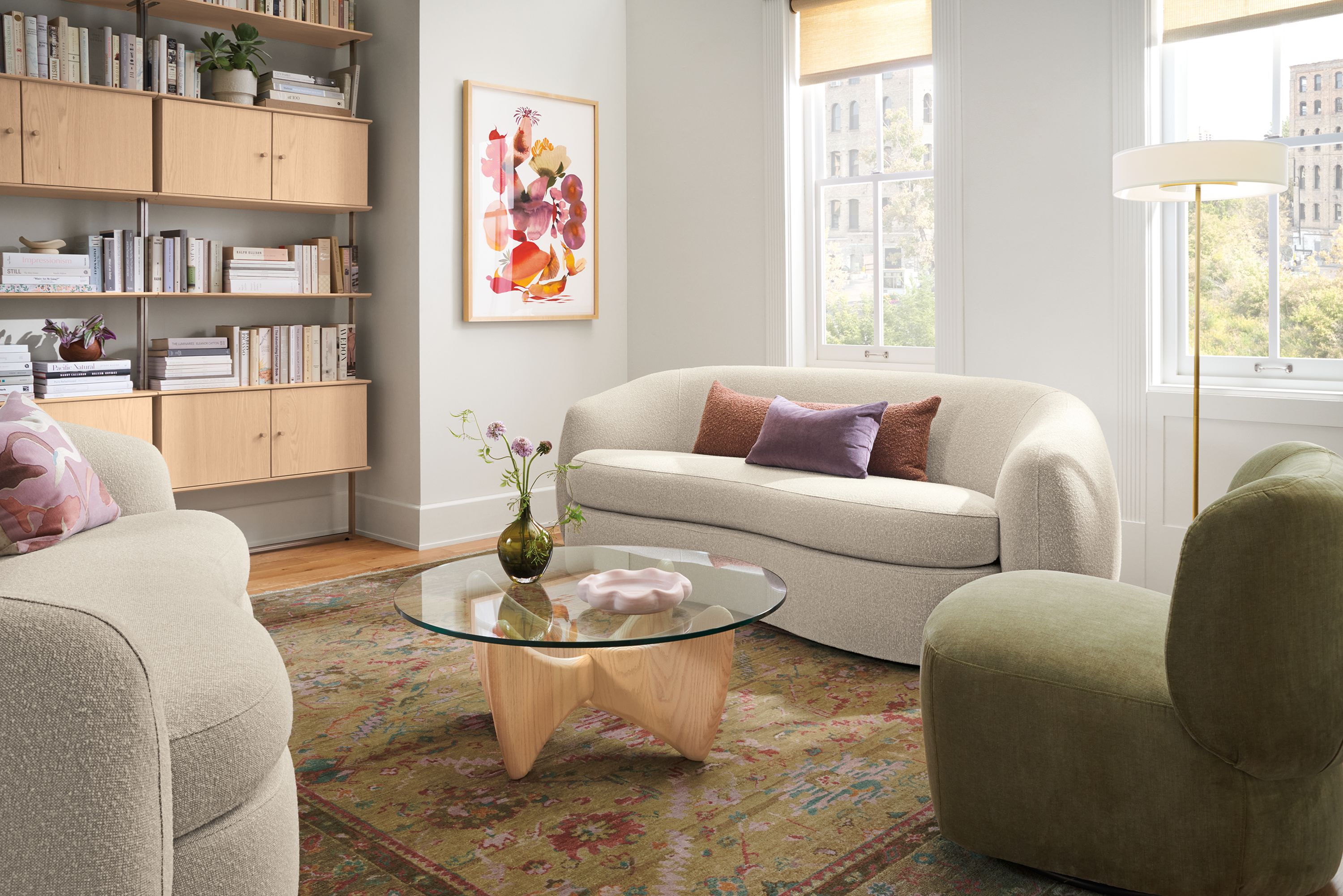Sunny living room with Valora 86-wide benchseat sofa in conley natural and sanders 36-diameter coffee table in salt on red oak.