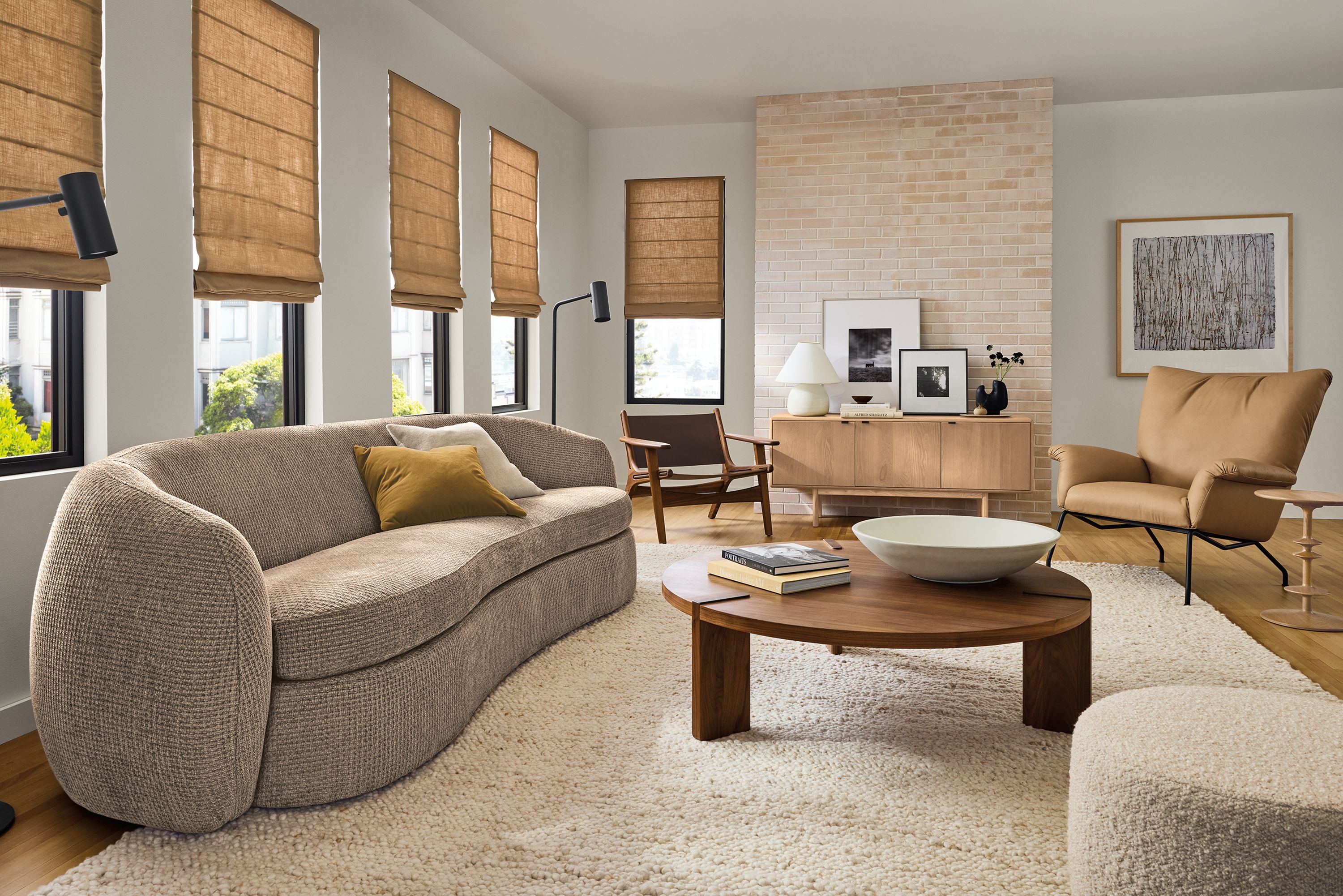 Large living room with Valora 106-wide sofa in zenith putty, paris chair in fiero camel leather and hanover 48-diameter coffee table in walnut.