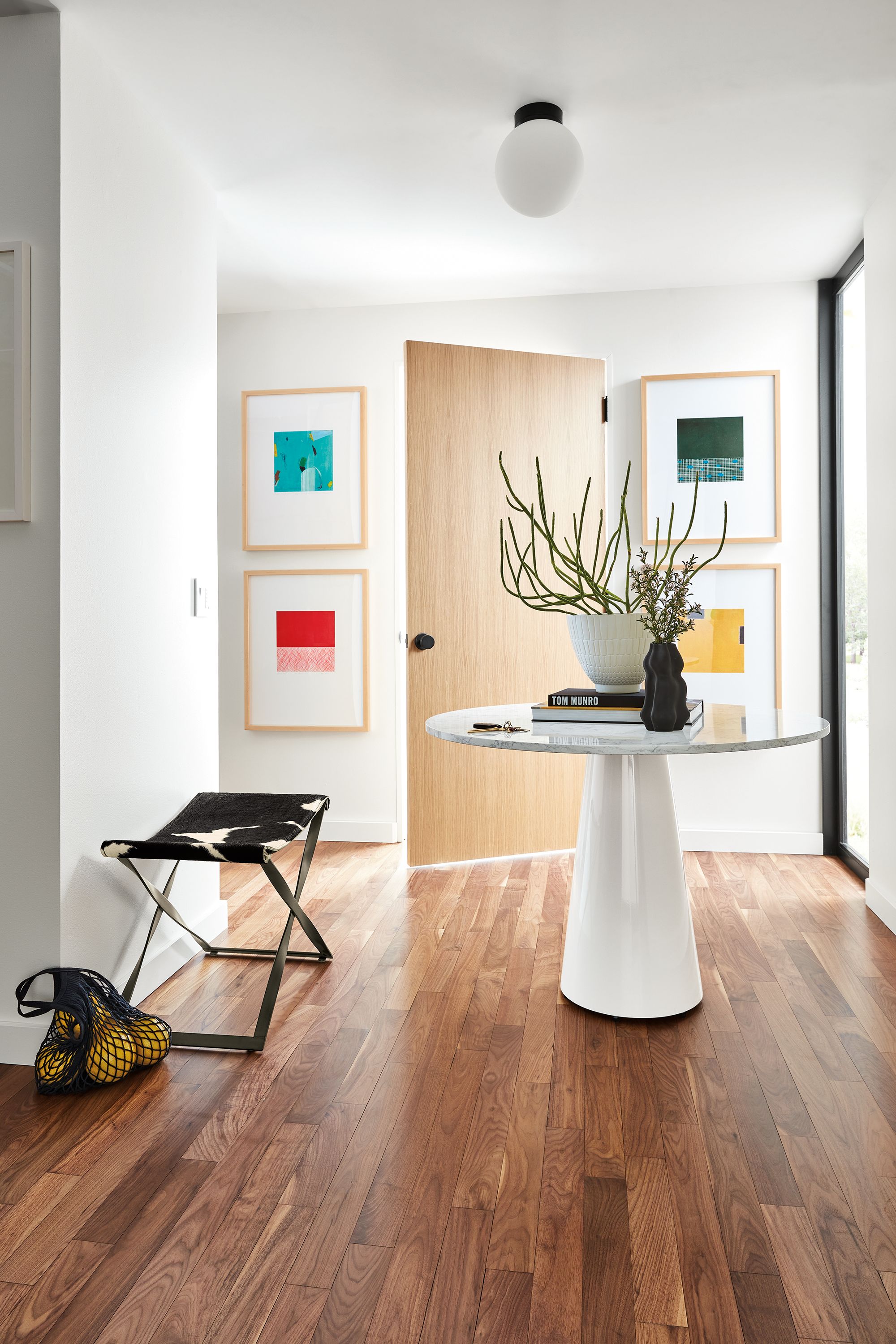 detail of juni van dyke prints, decker table, karr stool, orbit sconce.