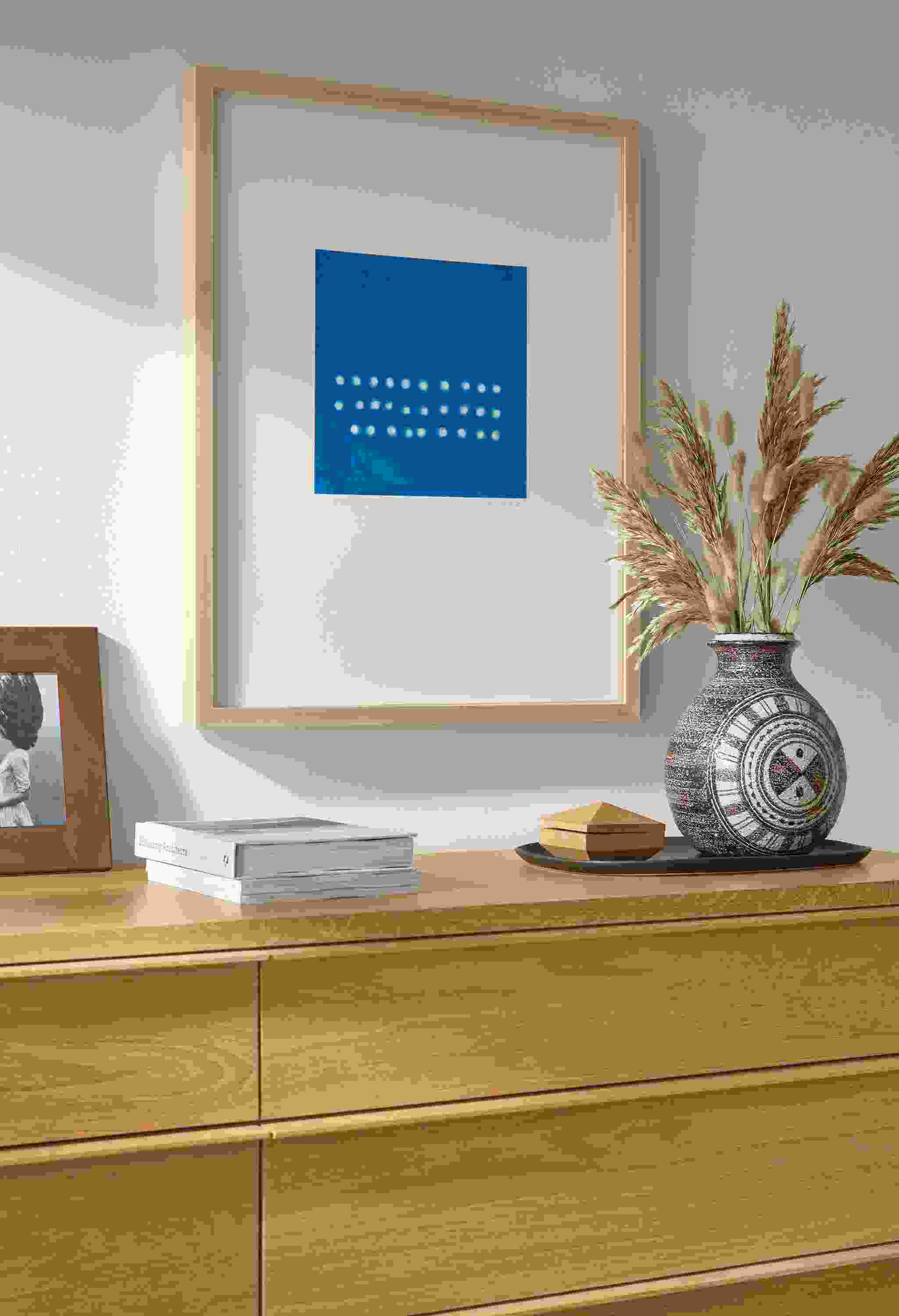 Detail of Juni Van Dyke blue untitled wall art above an Anton dresser in white oak.