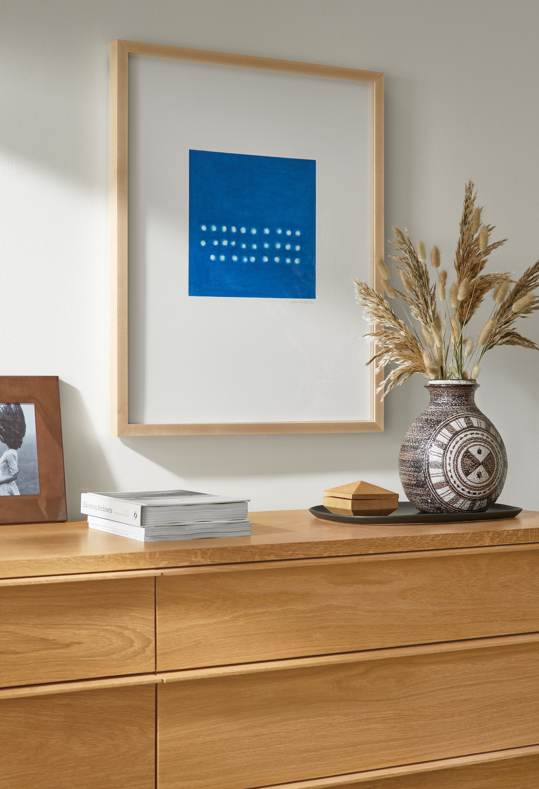Detail of Juni Van Dyke blue untitled wall art above an Anton dresser in white oak.
