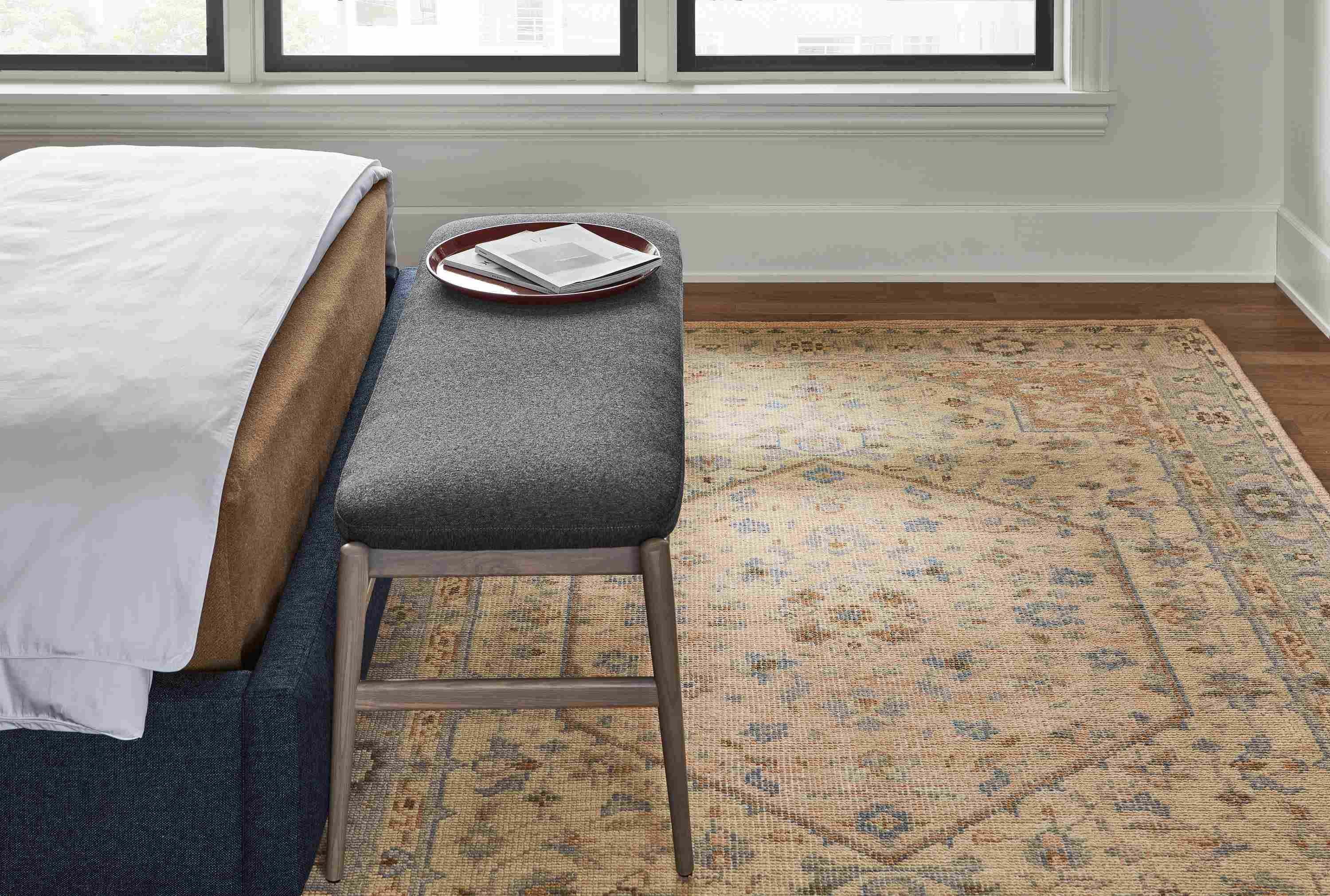 Detail of veda rug in camel, evan bench in flint charcoal, garner tray and avery bed.