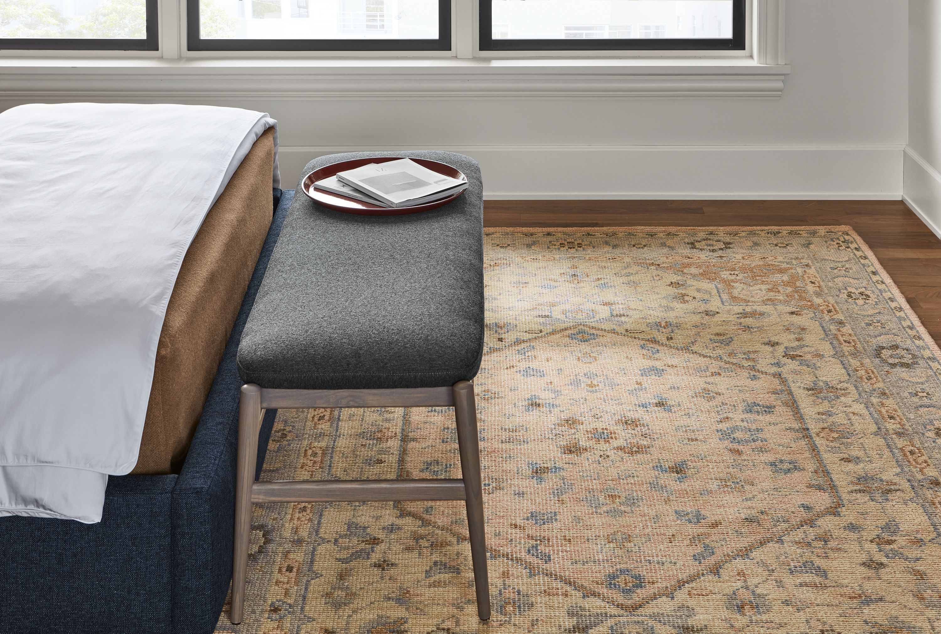 Detail of veda rug in camel, evan bench in flint charcoal, garner tray and avery bed.