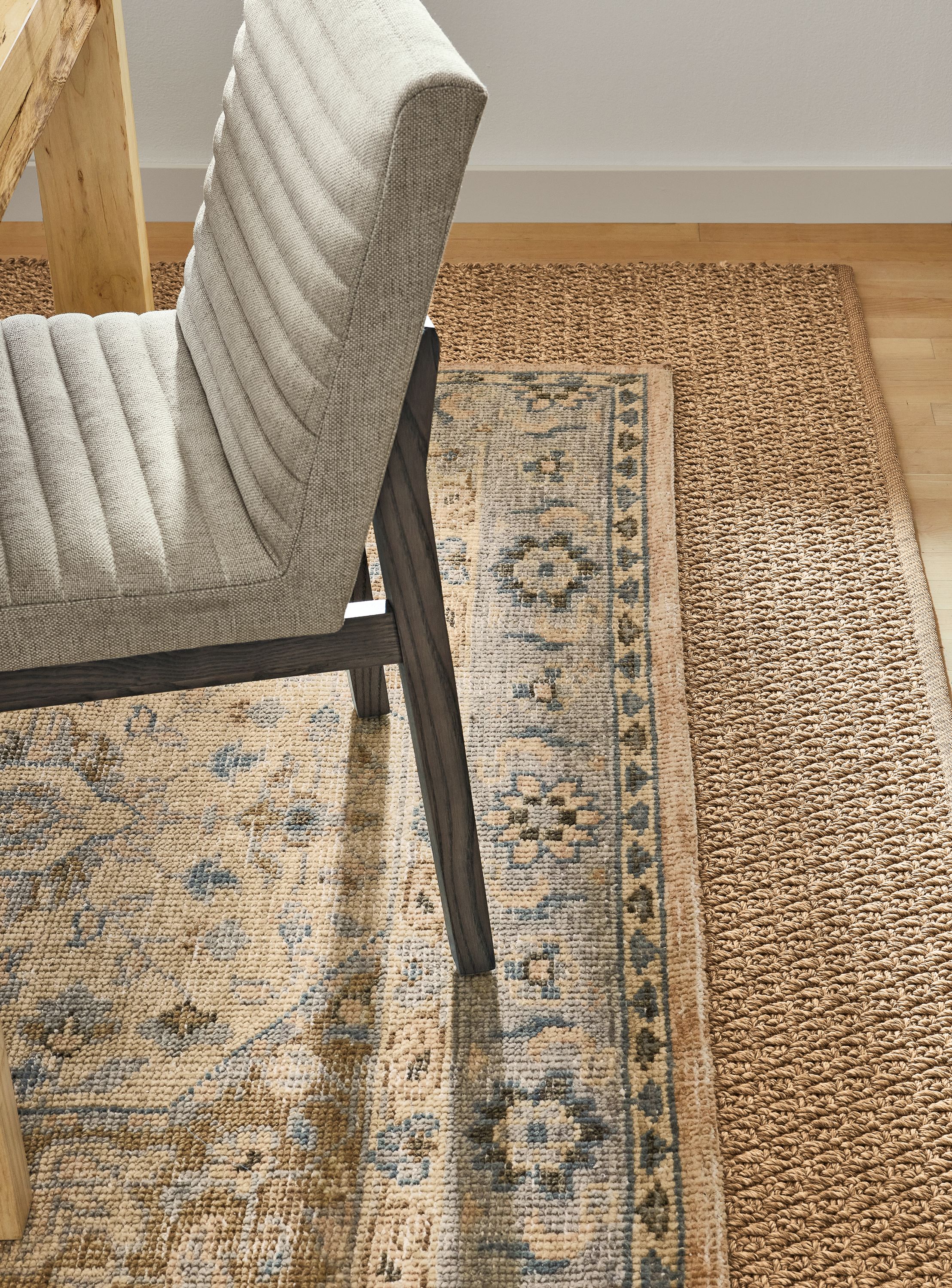 Detail of veda rug, essence rug, walsh table, olsen side chair.