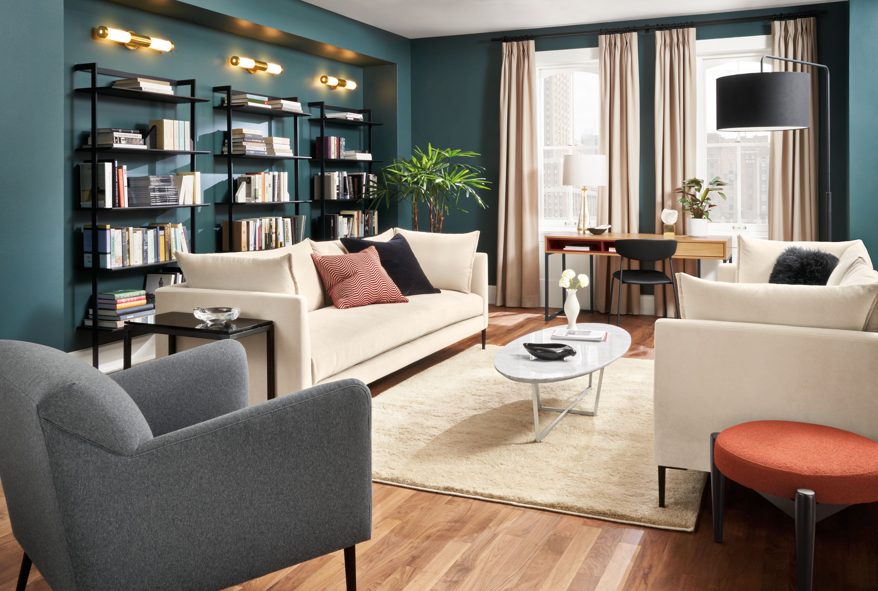 Living room with 2 Vela bench-cushion sofa in banks natural and Matteo chair in Flint Charcoal.