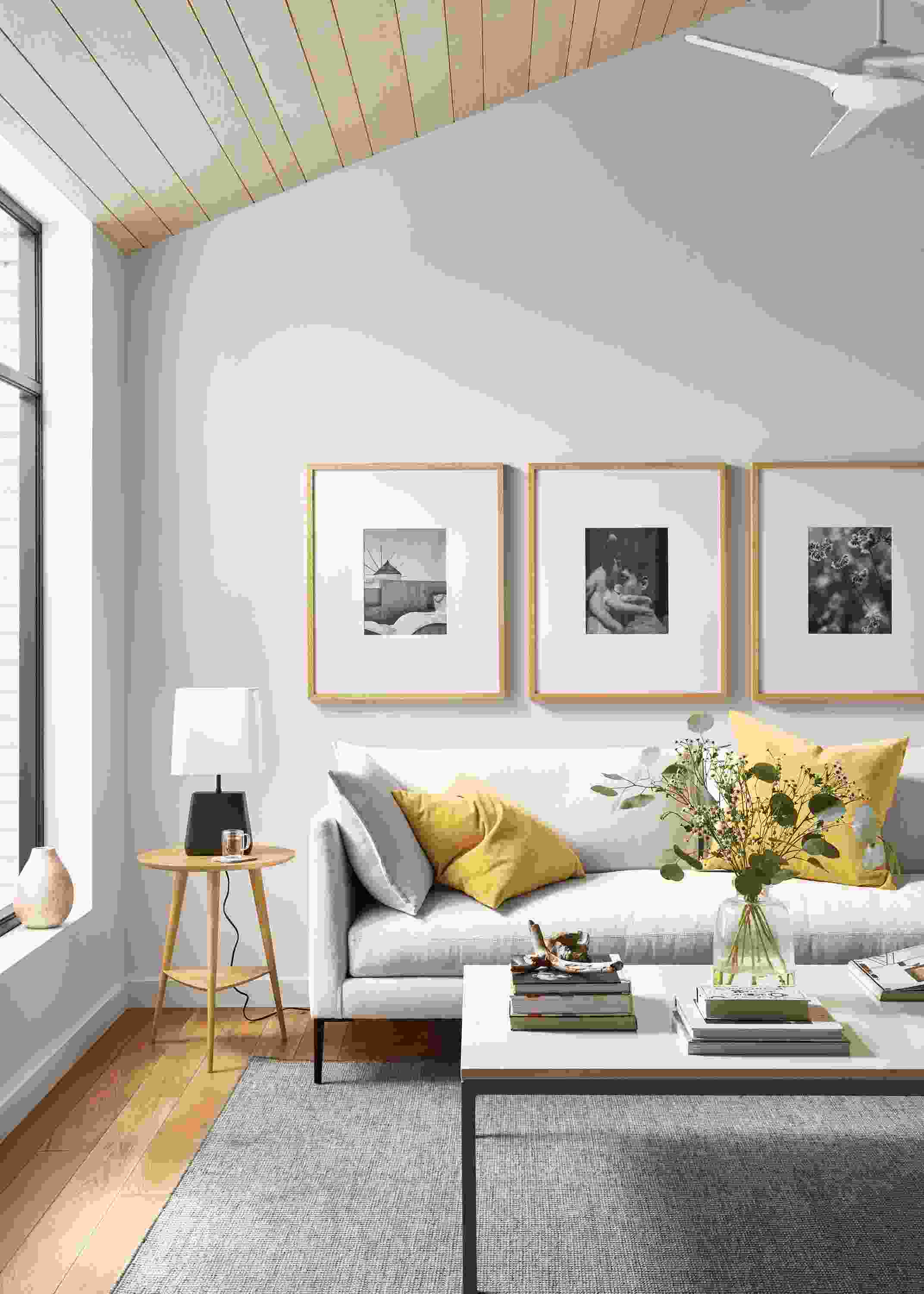 Living room with Vela bench-cushion sofa in Sumner Ivory and Selby rug in taupe.