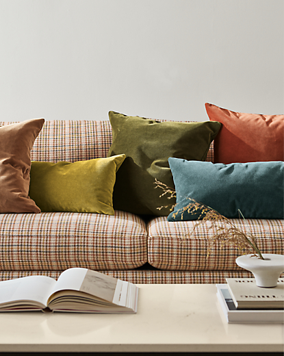 detail of colorful velvet pillows on jasper sofa.