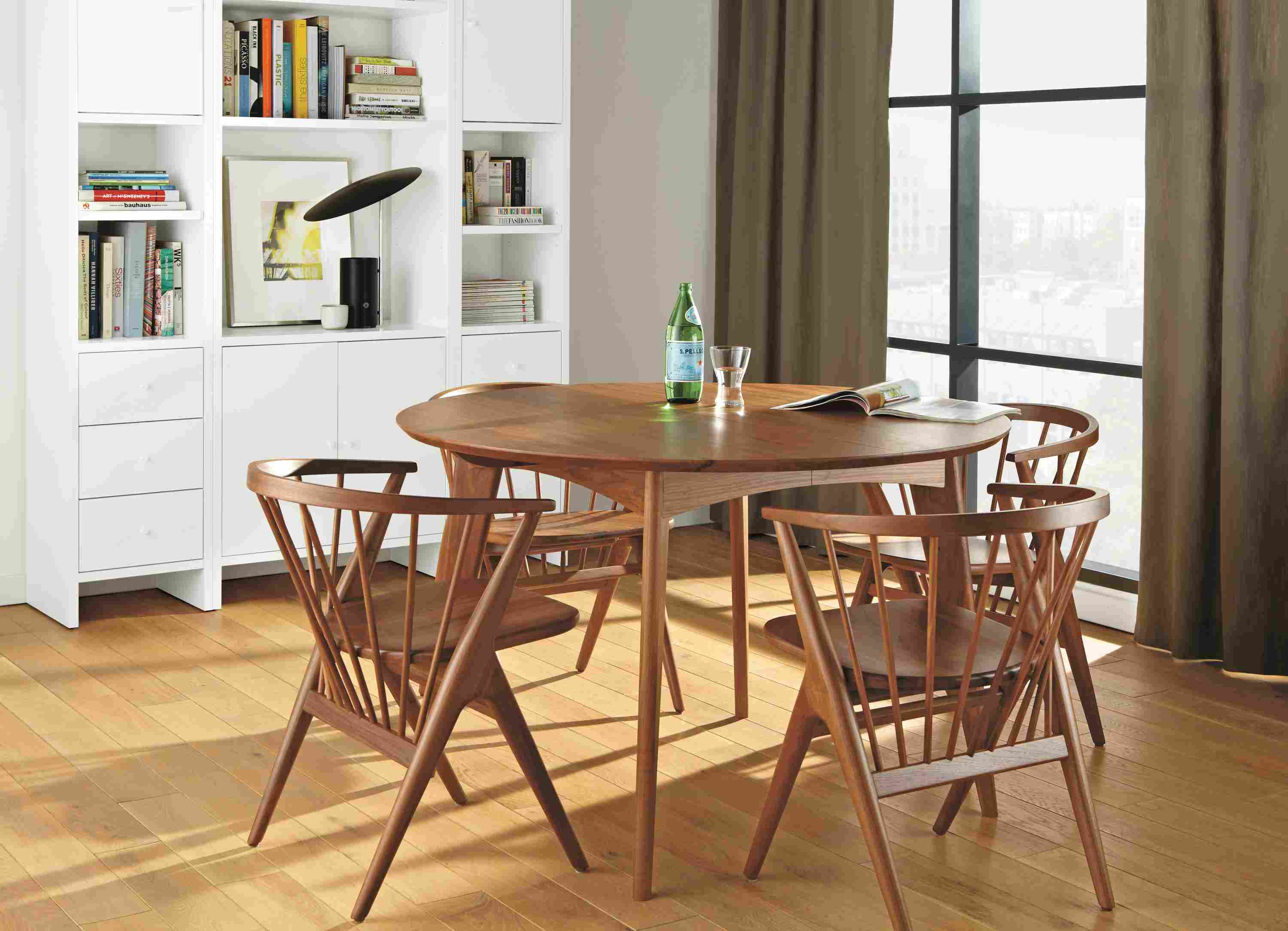 Dining room with Ventura round extension dining table in walnut and 4 Soren dining chairs in walnut.