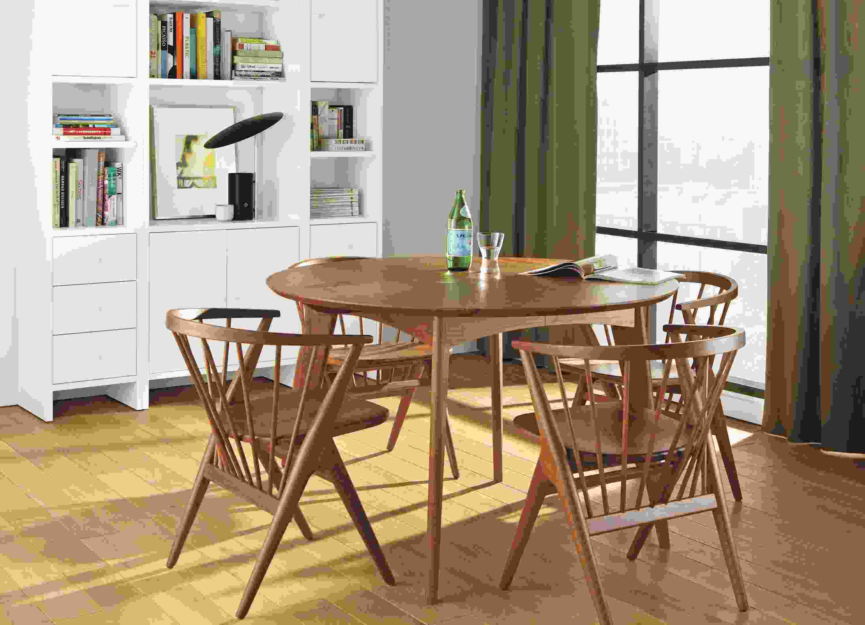 Dining room with Ventura round extension dining table in walnut and 4 Soren dining chairs in walnut.