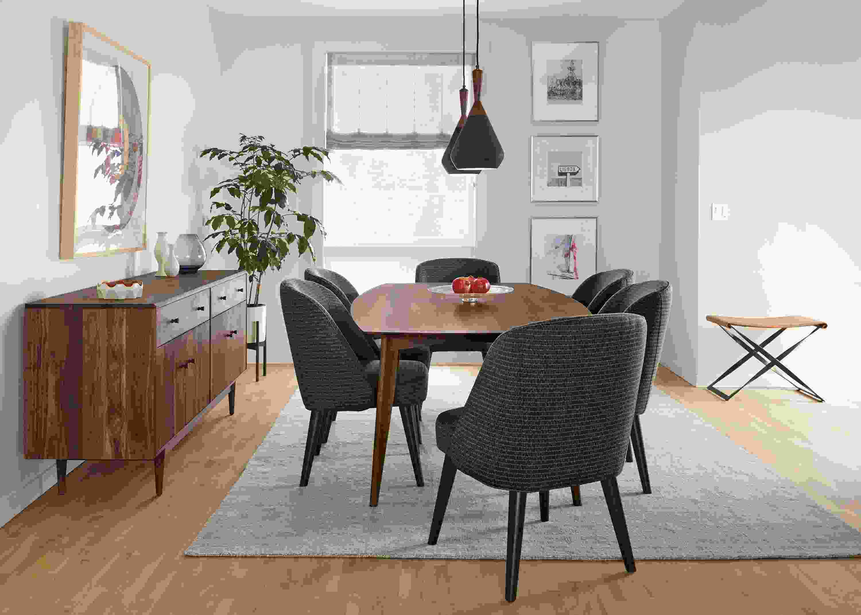 Dining room with Ventura dining table in walnut, grove storage cabinet in walnut and Bryson rug in cement.