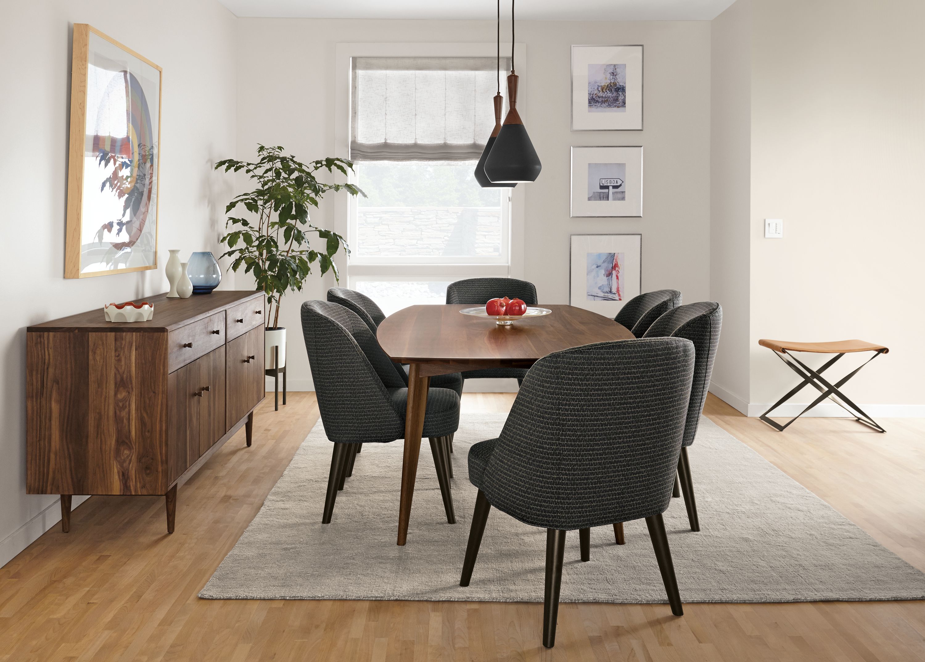 Dining room with Ventura dining table in walnut, grove storage cabinet in walnut and Bryson rug in cement.