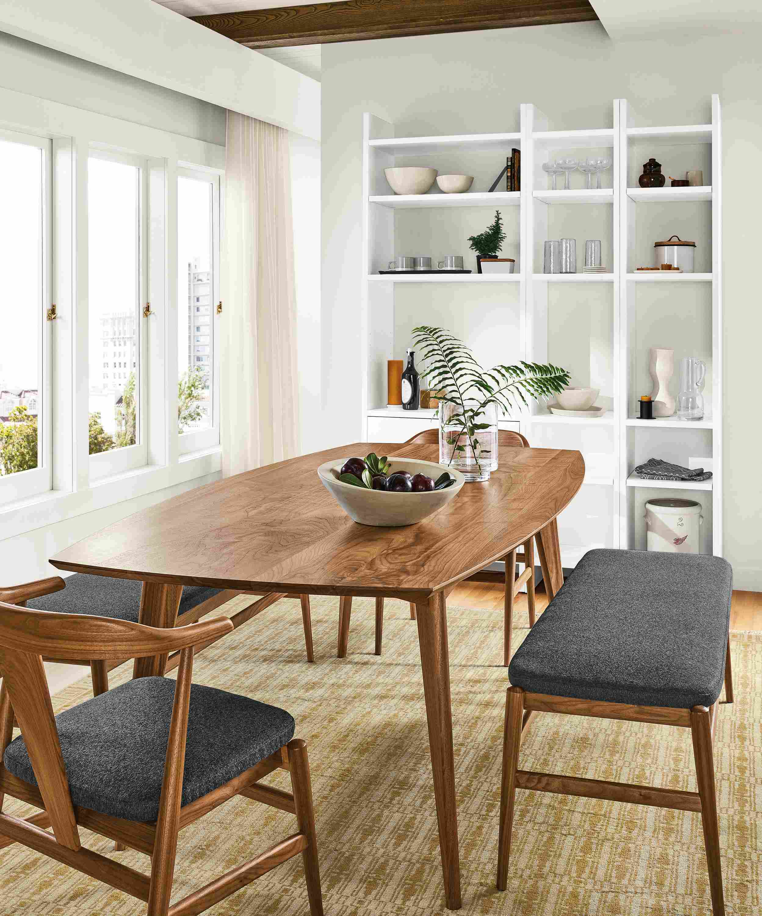 Dining room with Ventura table and Evan chairs and bench all in walnut and Tulum rug in wheat.