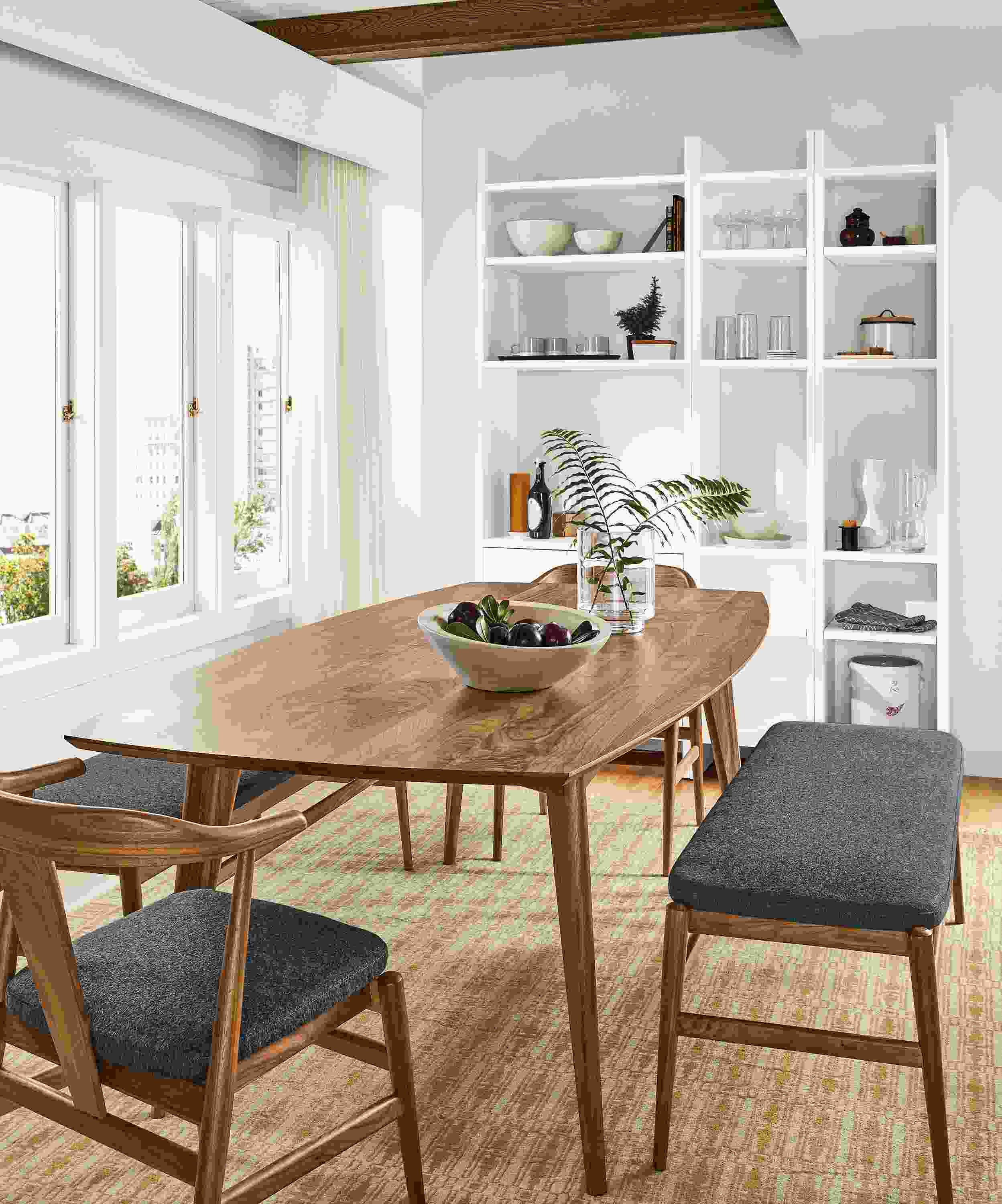 Dining room with Ventura table and Evan chairs and bench all in walnut and Tulum rug in wheat.