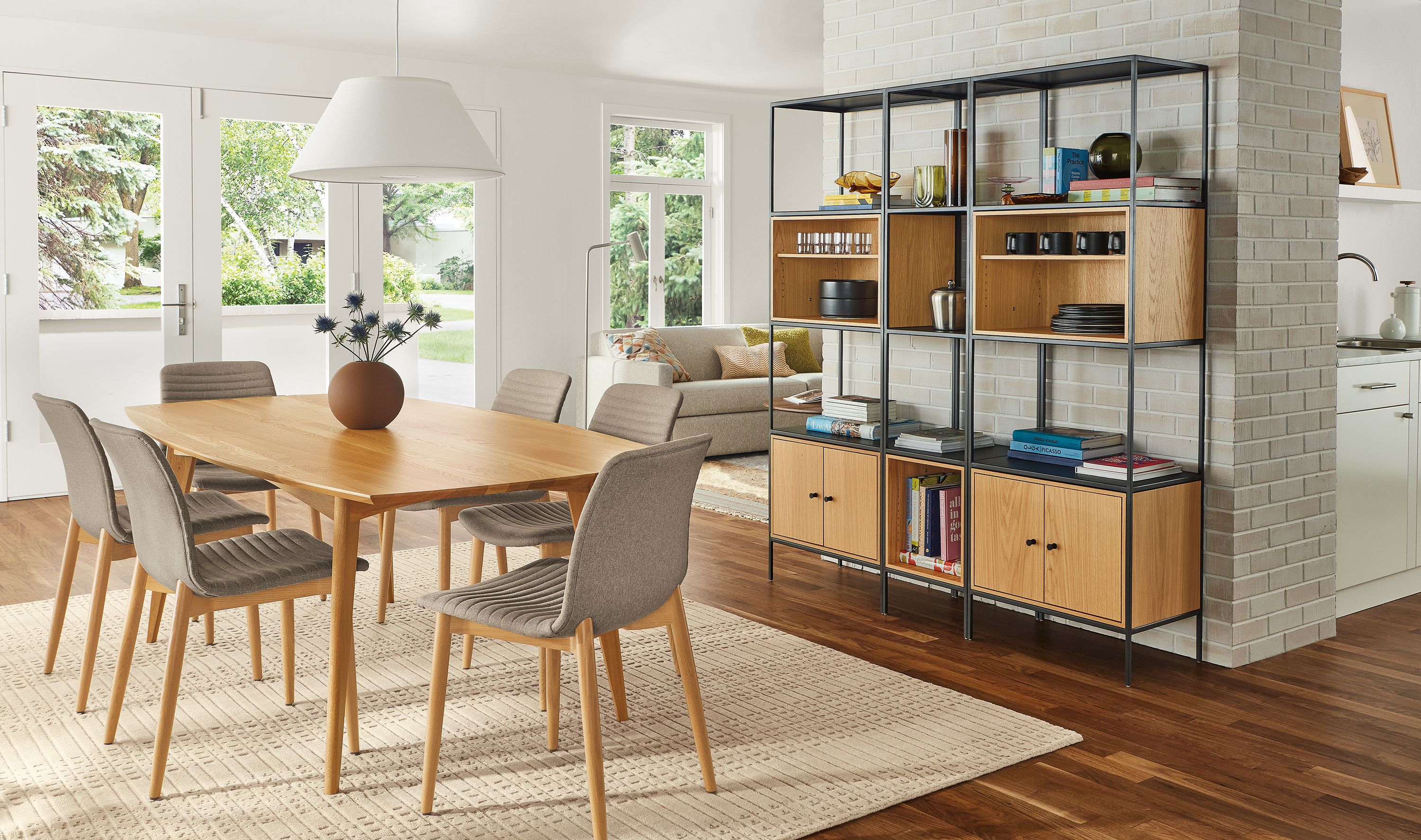 Dining room with Ventura 84-wide table in white oak, Cato chairs, and Slim 5 insert wall unit in natural steel and white oak.