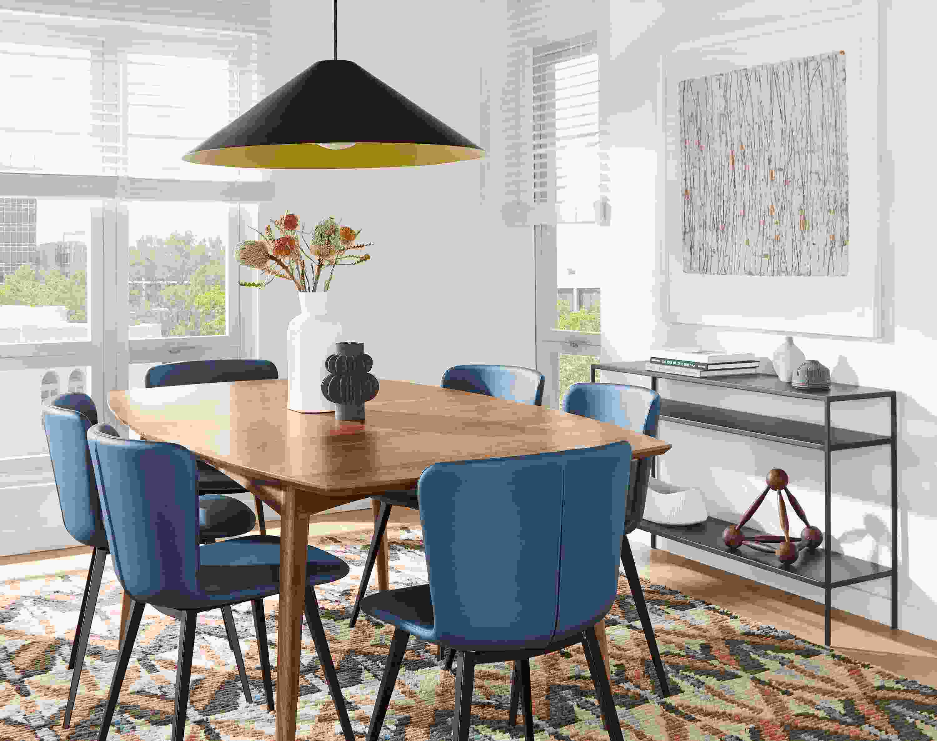 Dining room with Ventura extension table in walnut and Delilah dining chairs with blue leather seats.