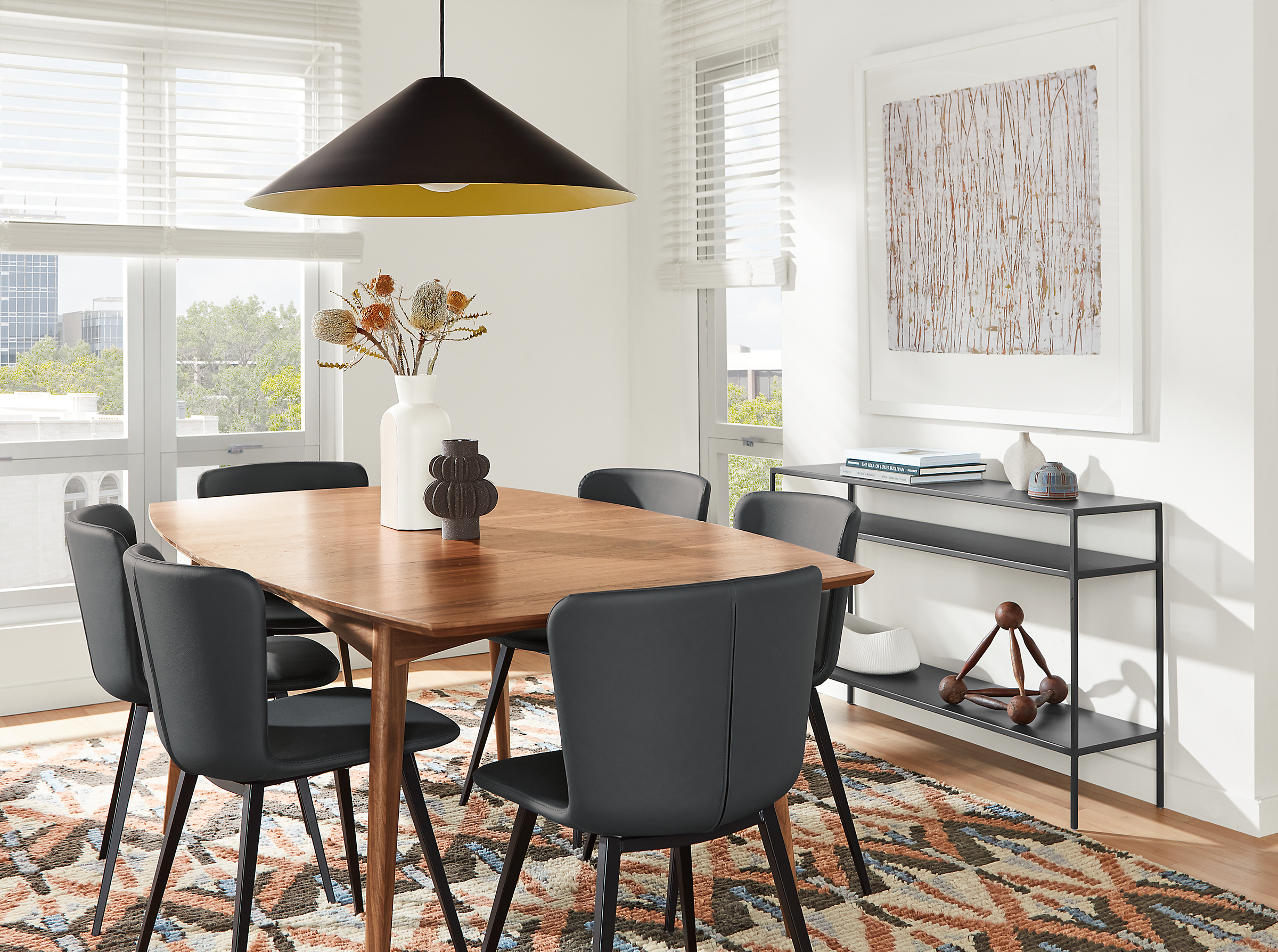 dining room with ventura extension table in walnut and delilah dining chairs with black leather seats.