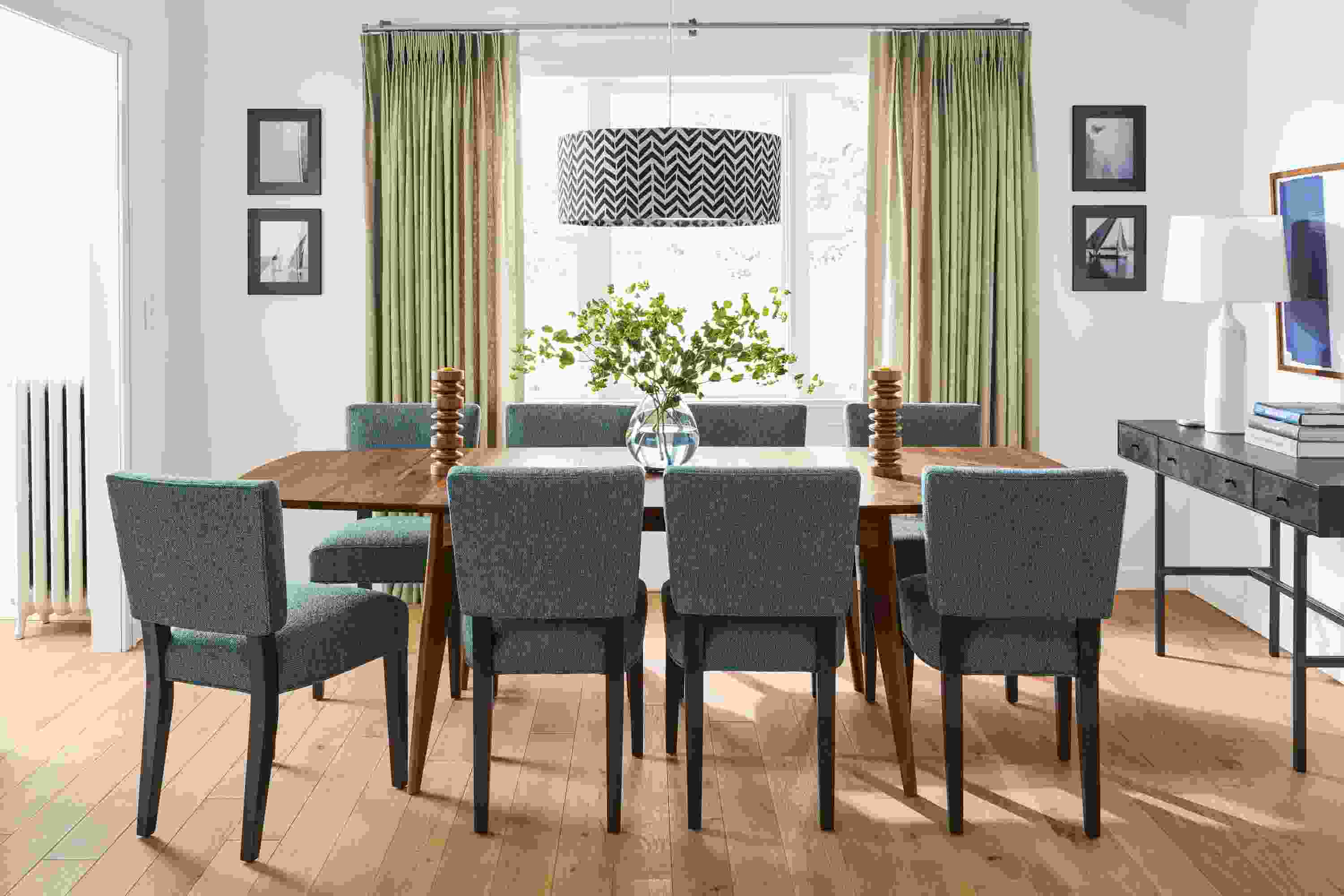 Detail of extension Ventura dining table in walnut and 8 Georgia side chairs in Tepic Haze with charcoal legs.