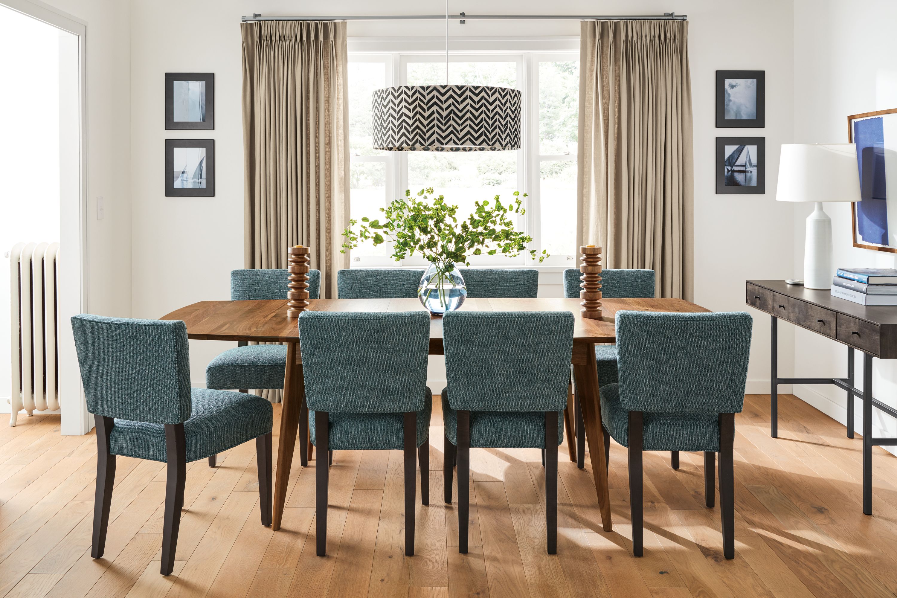 Detail of extension Ventura dining table in walnut and 8 Georgia side chairs in Tepic Haze with charcoal legs.
