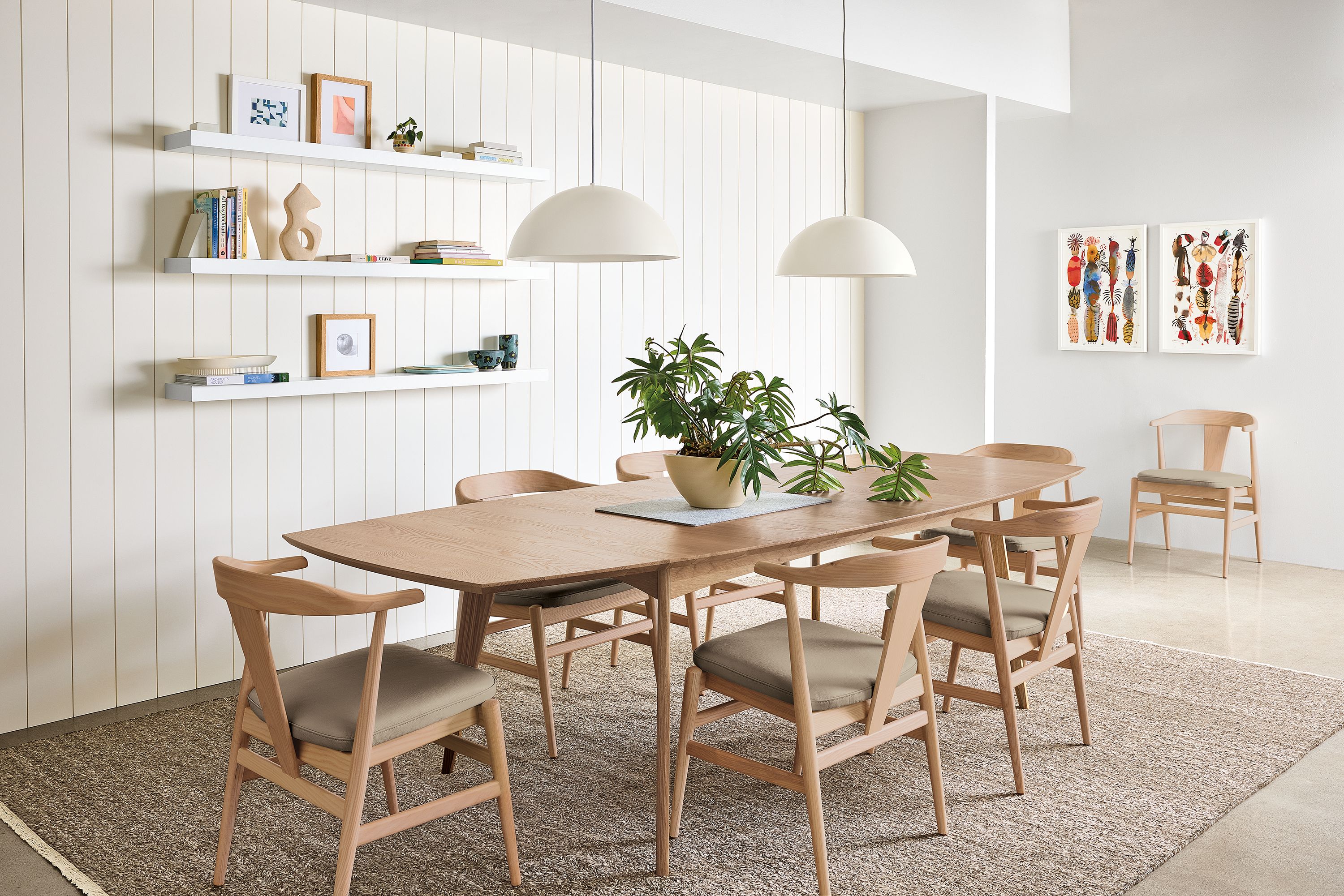 Dining room with Ventura 84-wide table and 7 Evan arm chairs in rye on red oak.