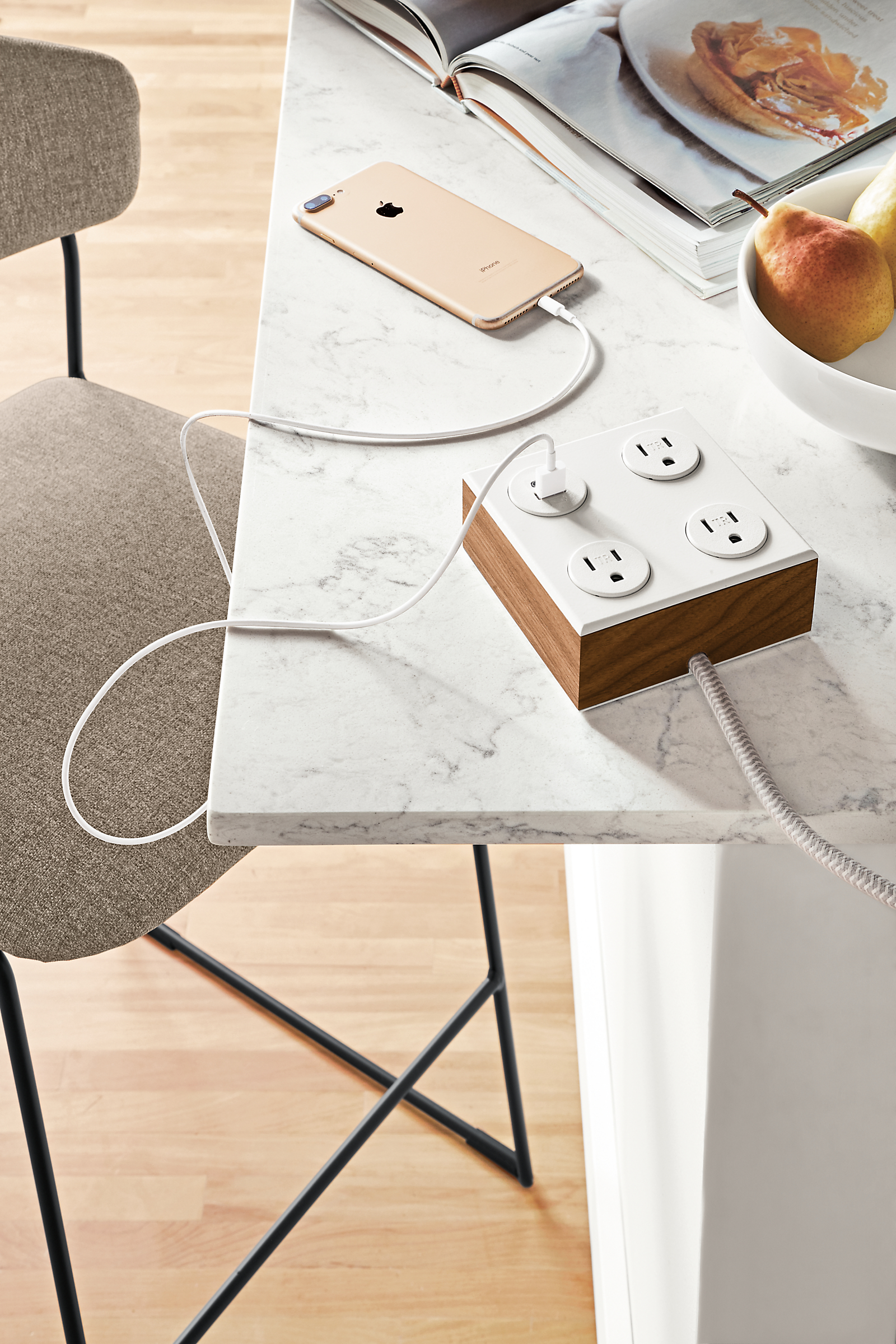 Detail of Verve tabletop power outlet in walnut and white.