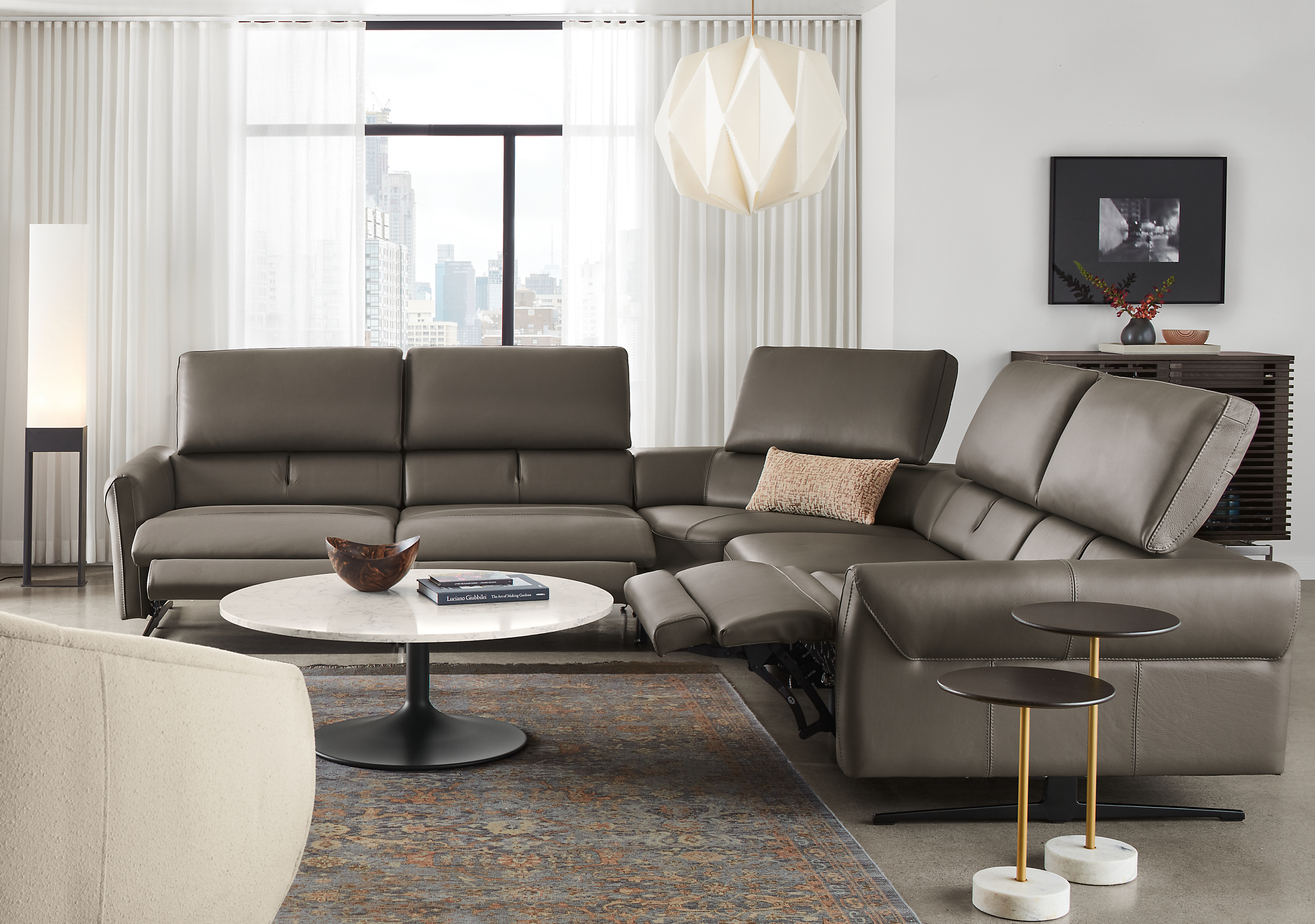 living room with vesna L-shaped sectional in nikola leather with all headrests extended and all footrests extended