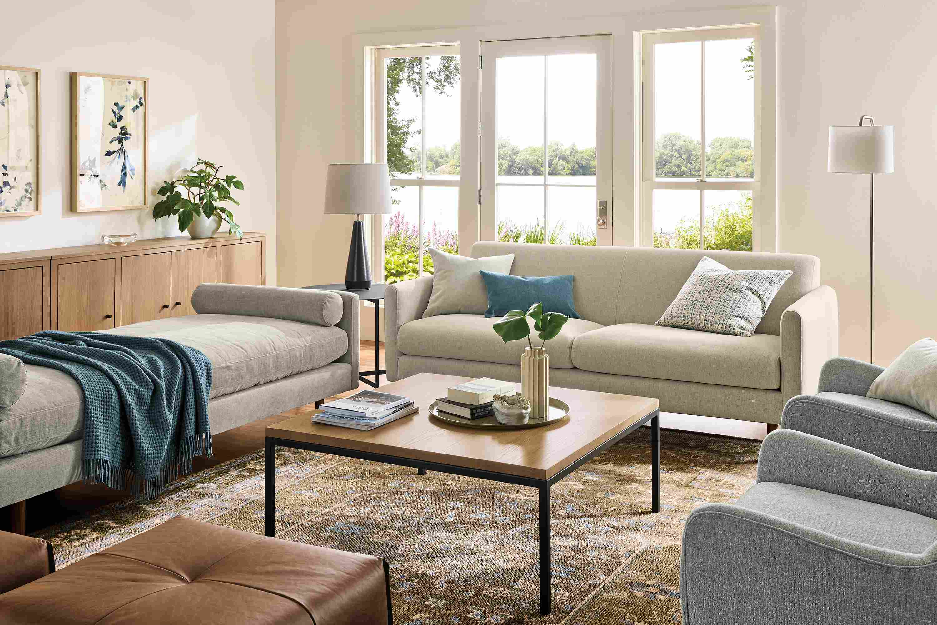 Living room with vienna sofa in sumner linen, jasper daybed in mori cement and veda 9 by 12 rug in moss.
