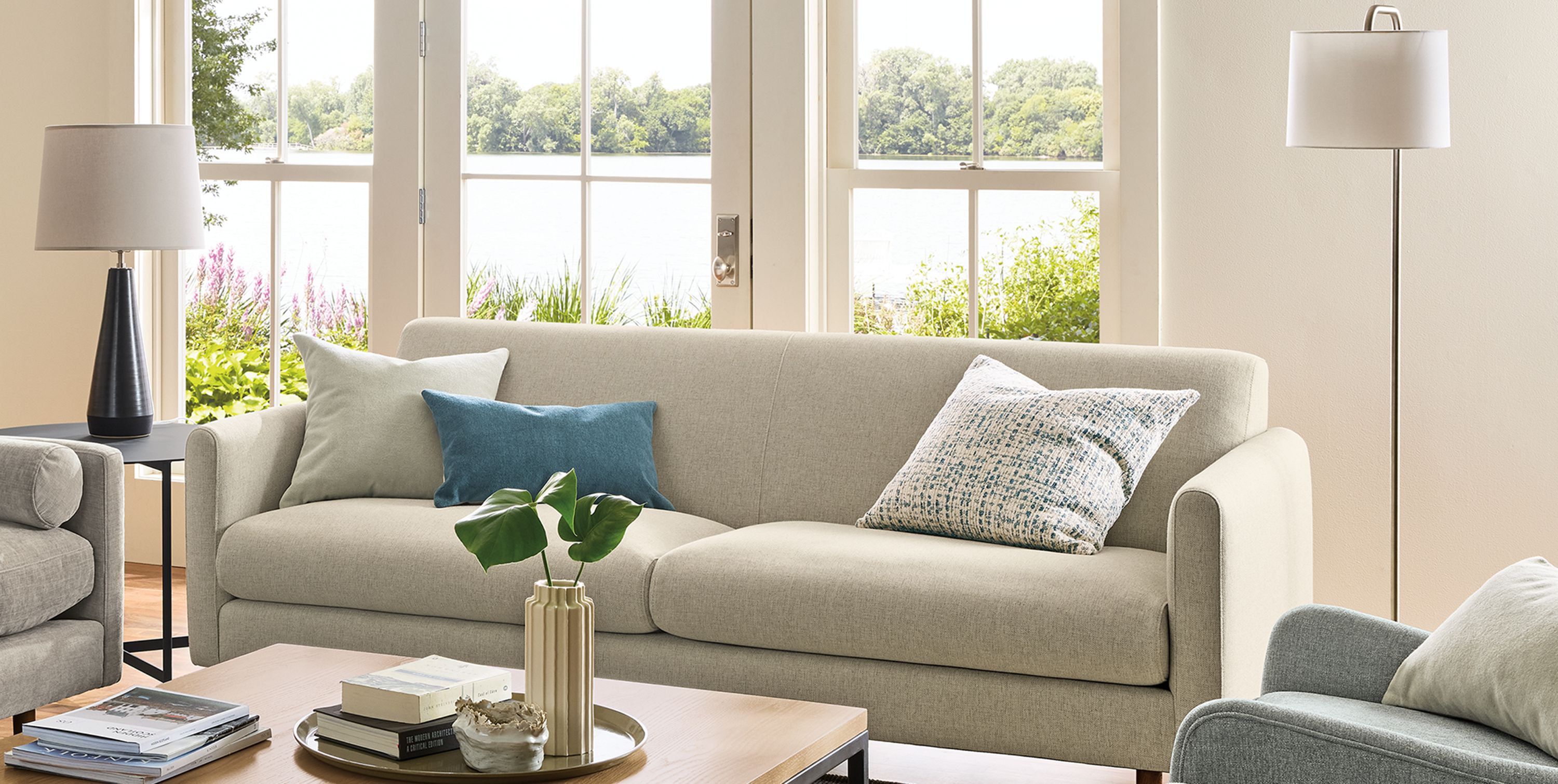 Living room with vienna sofa in sumner linen, jasper daybed in mori cement and veda 9 by 12 rug in moss.