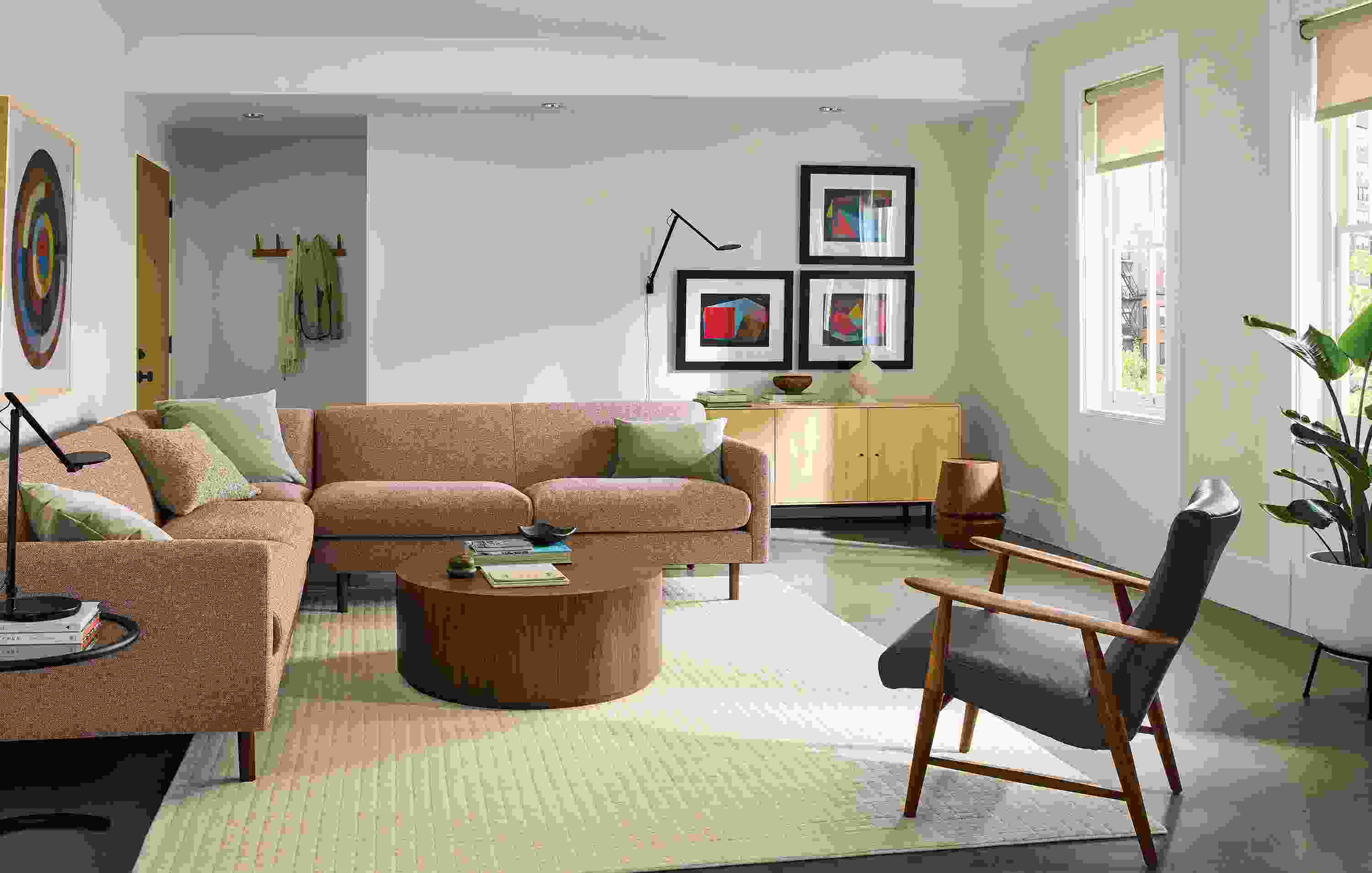 Living room with vienna 112 by 112 sectional in tatum clay, liam coffee table in walnut and nyla stool.