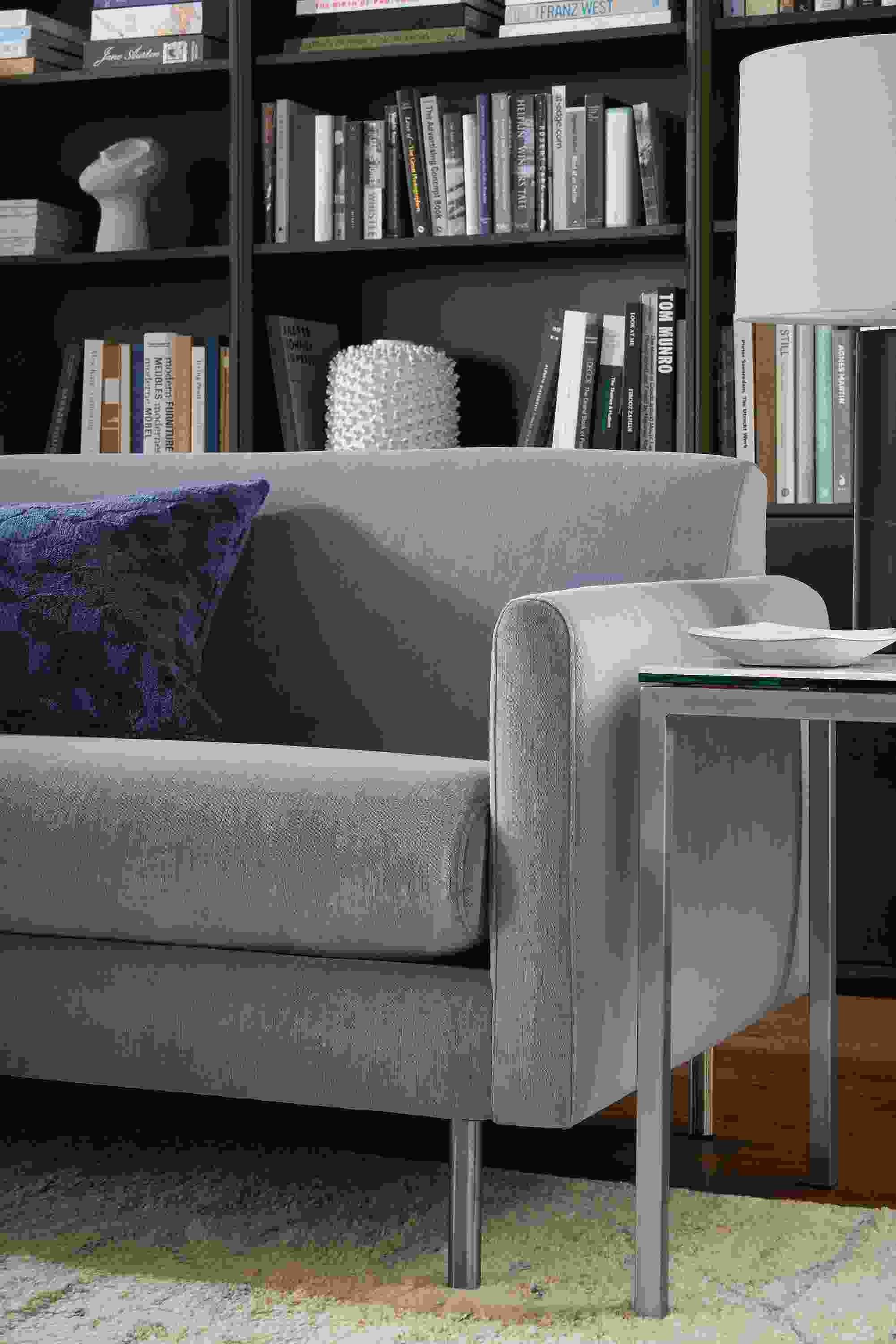 Living room with detail of Vienna sofa in windsor denim and parsons end table in stainless with white marble ceramic top.