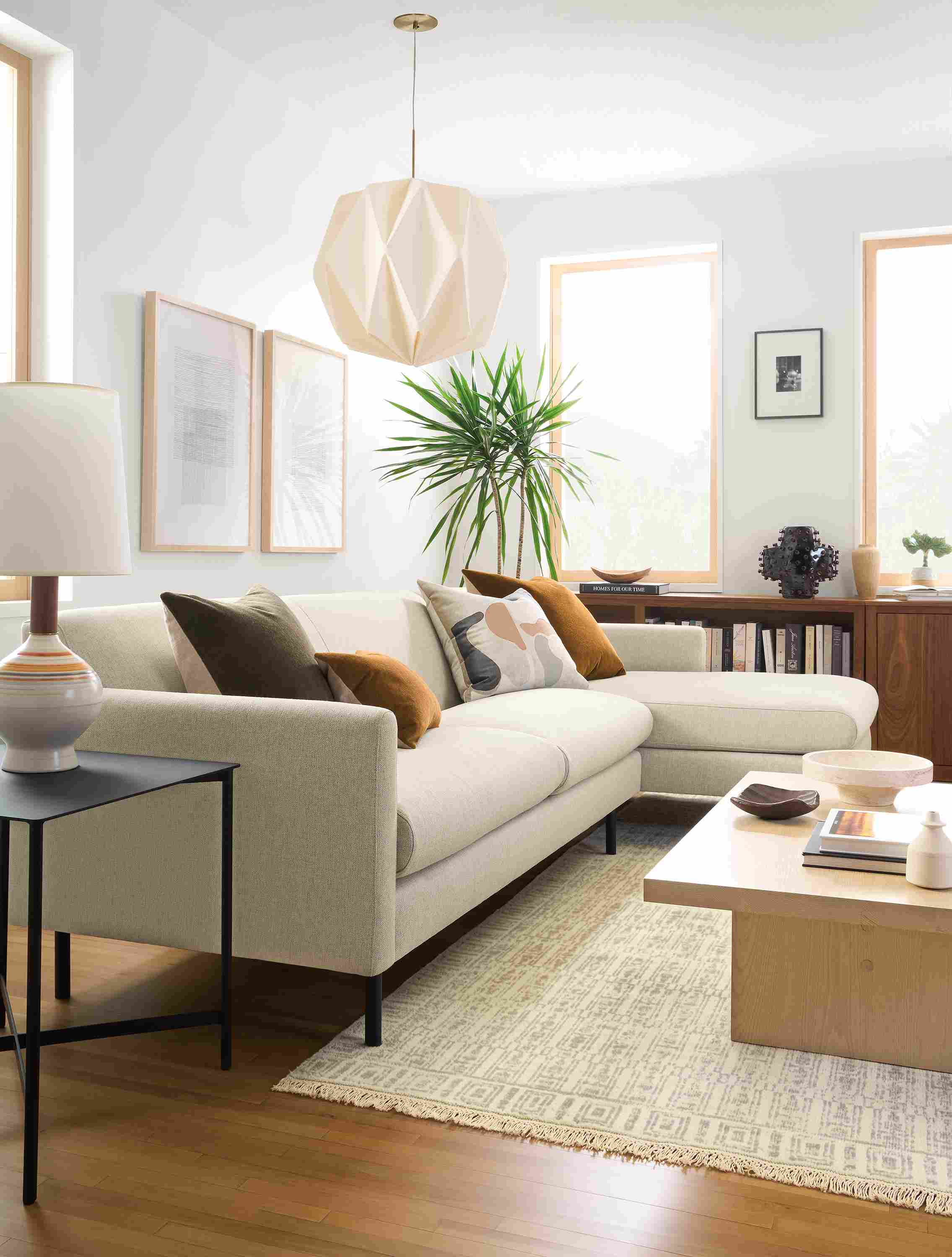 Living room with vienna sofa with right arm chaise in sumner linen and tulum 8 by 10 rug in taupe.