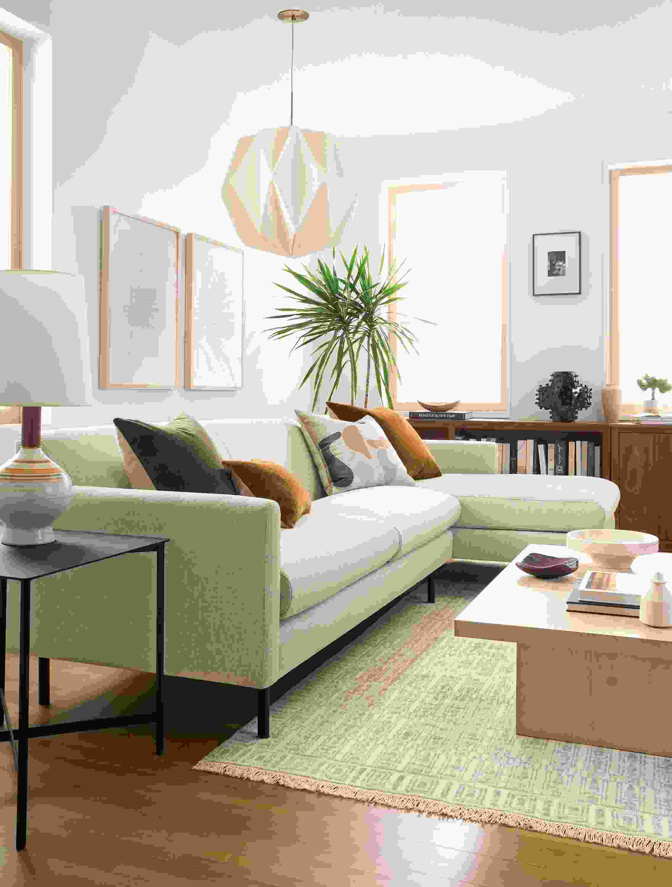 Living room with vienna sofa with right arm chaise in sumner linen and tulum 8 by 10 rug in taupe.