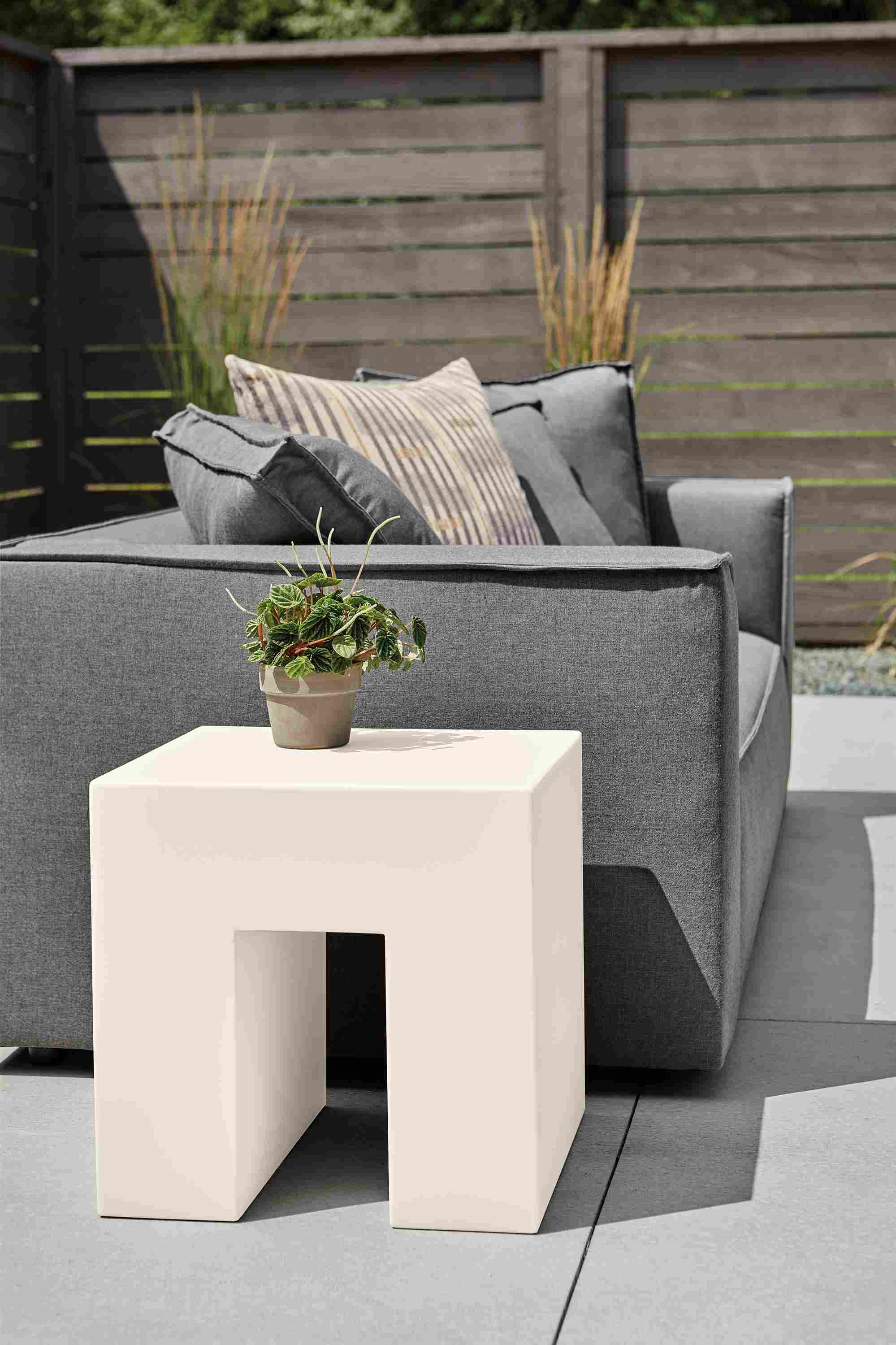 Outdoor patio with vignelli 18-square cube side table in bone with Oasis sofa in Sunbrella Canvas Slate.