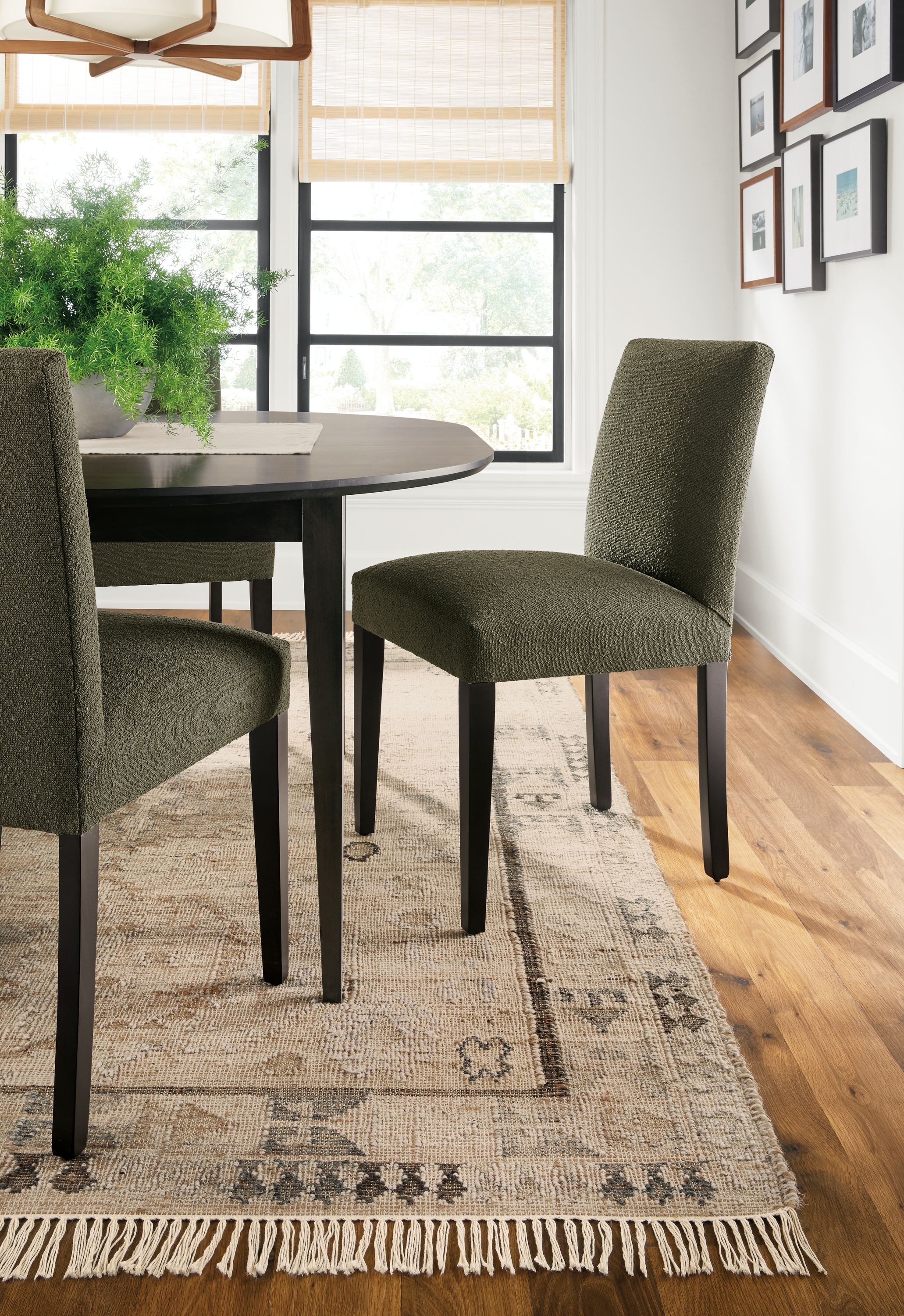 Detail of Villa rug in sand with Peyton side chairs in Declan Olive and Adams extension table in charcoal on maple.