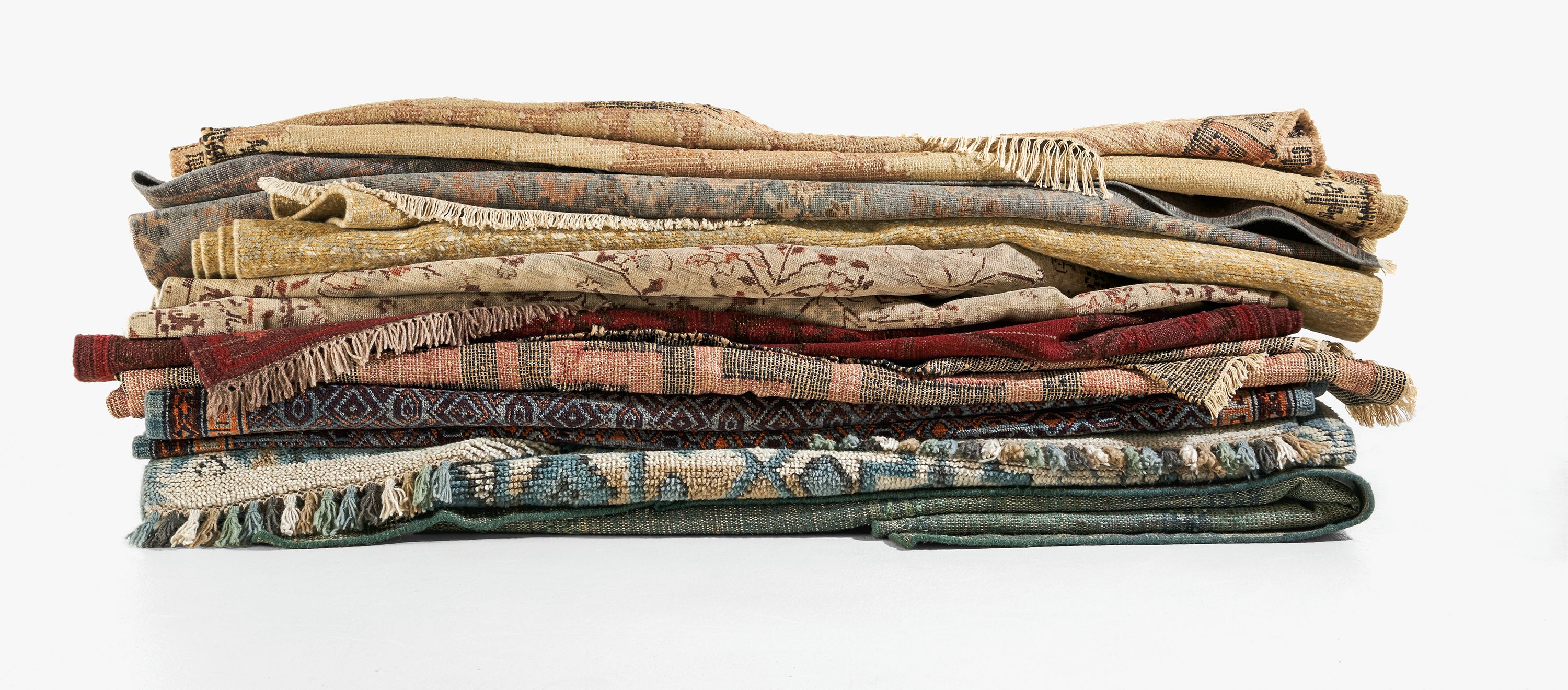 Detail of colorful wool rugs folded and stacked.
