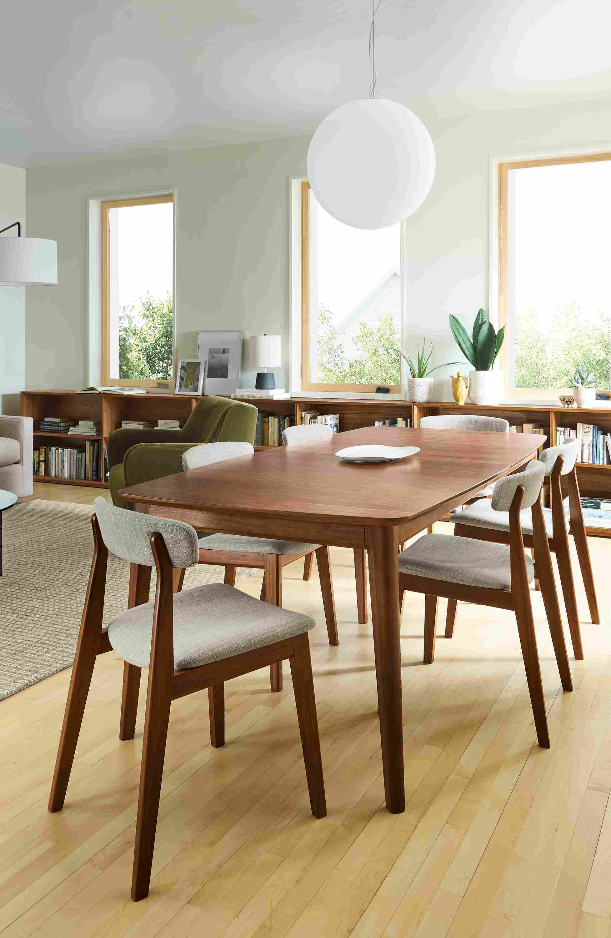 Dining area with Walcott 86-wide extension table in walnut and 6 Errol side chairs in walnut with Warner Putty.