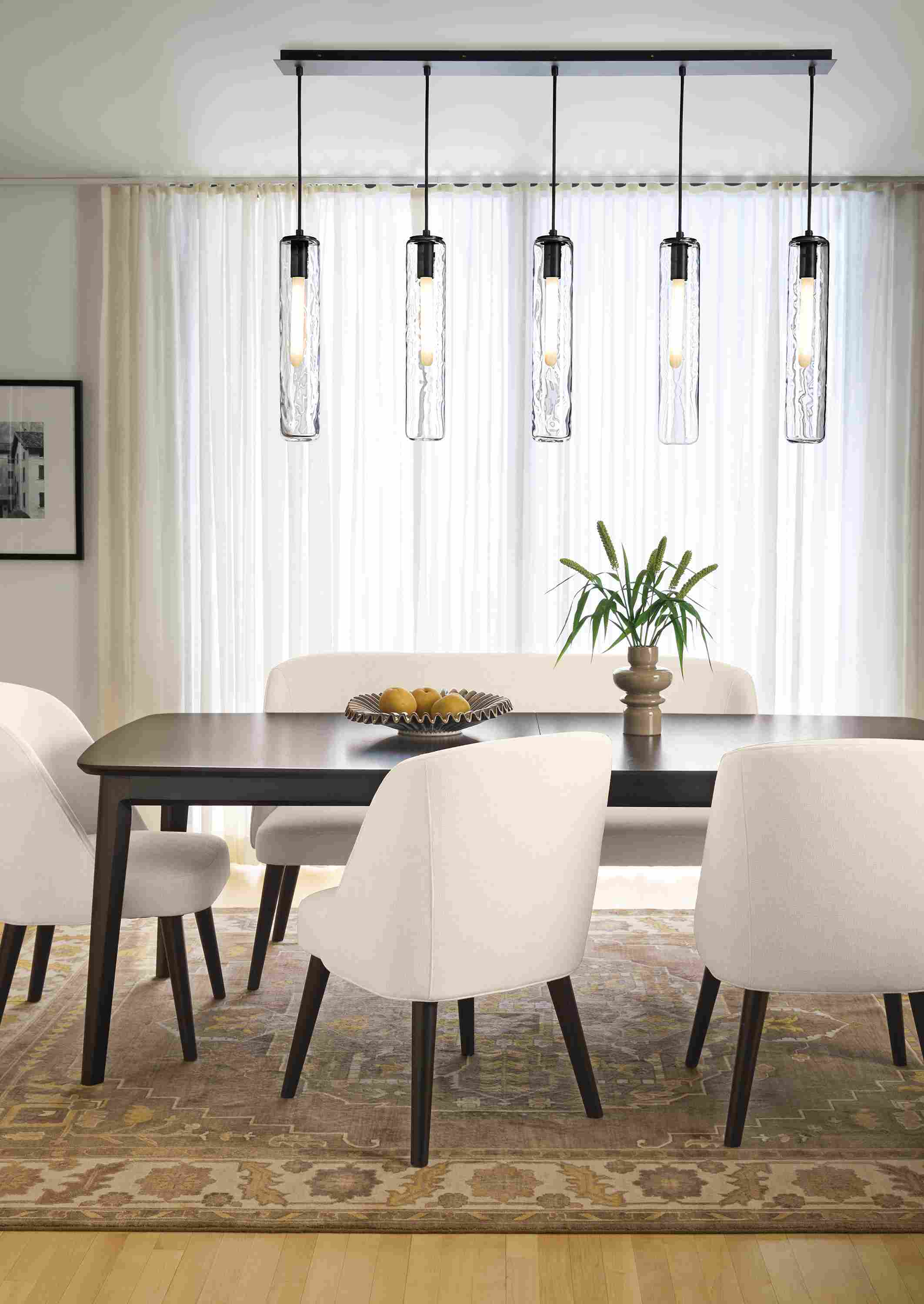 Dining room with Walcott 86-wide extension table in charcoal and Cora side chairs and bench in Sumner Ivory.