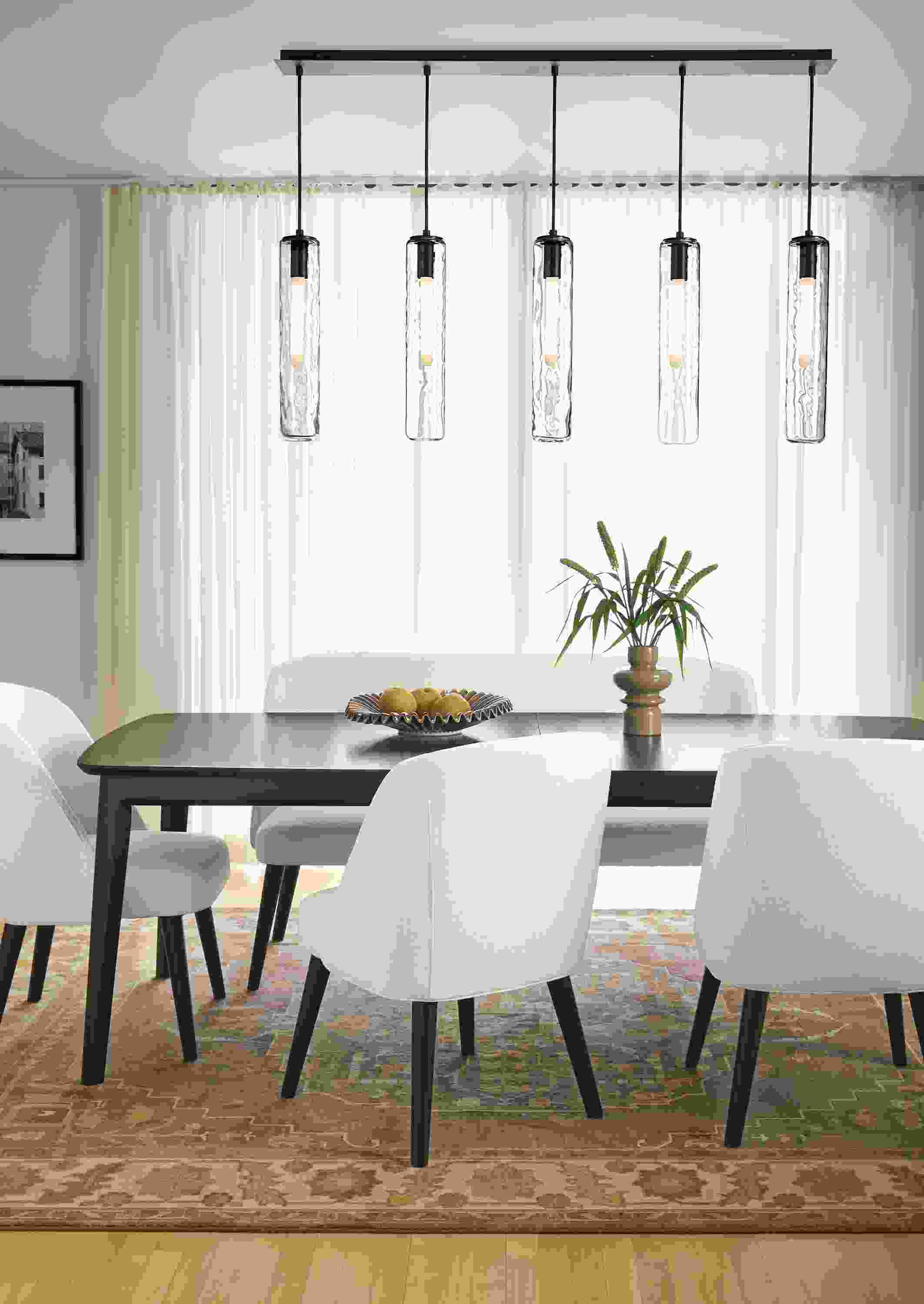 Dining room with Walcott 86-wide extension table in charcoal and Cora side chairs and bench in Sumner Ivory.