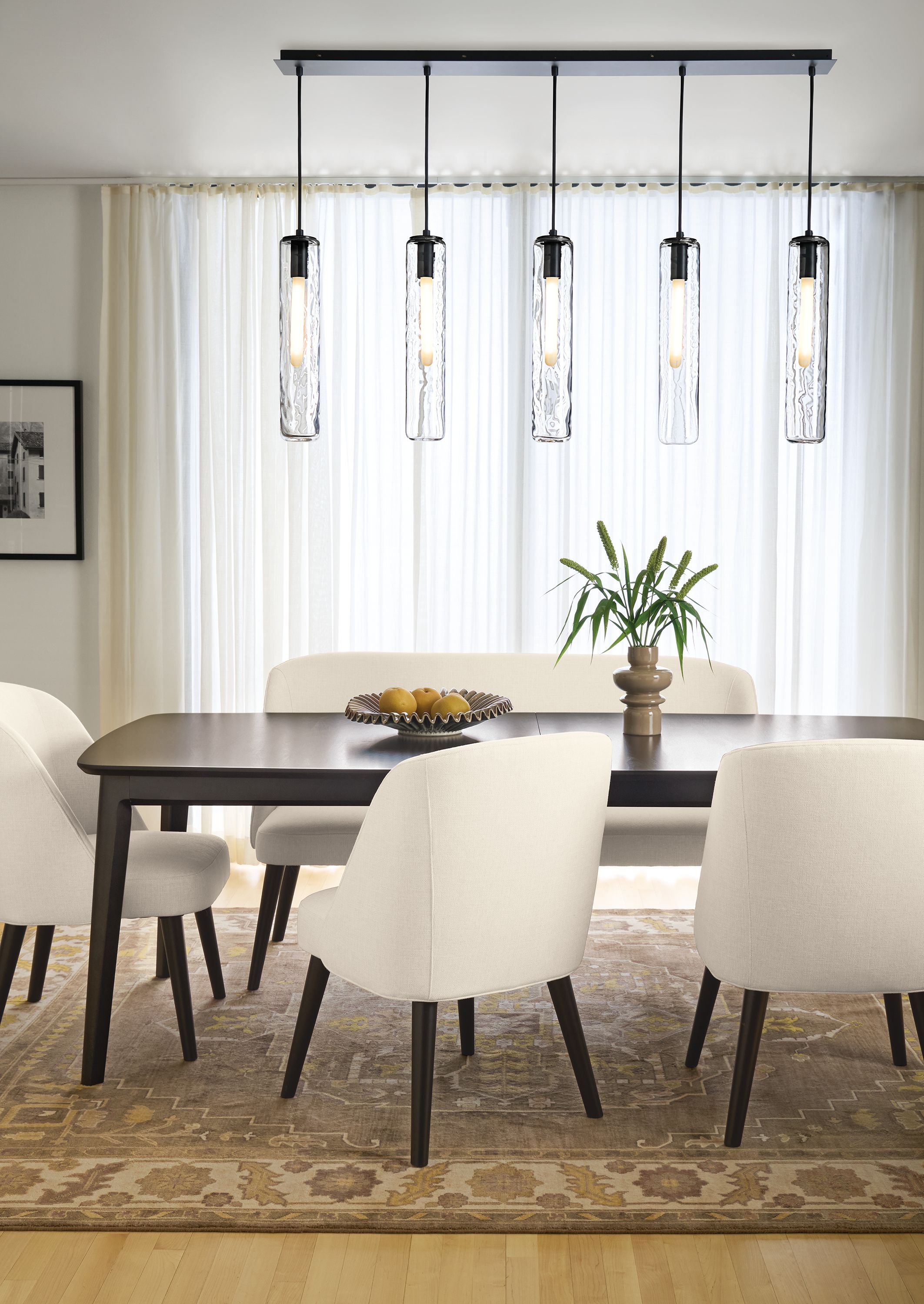 Dining room with Walcott 86-wide extension table in charcoal and Cora side chairs and bench in Sumner Ivory.
