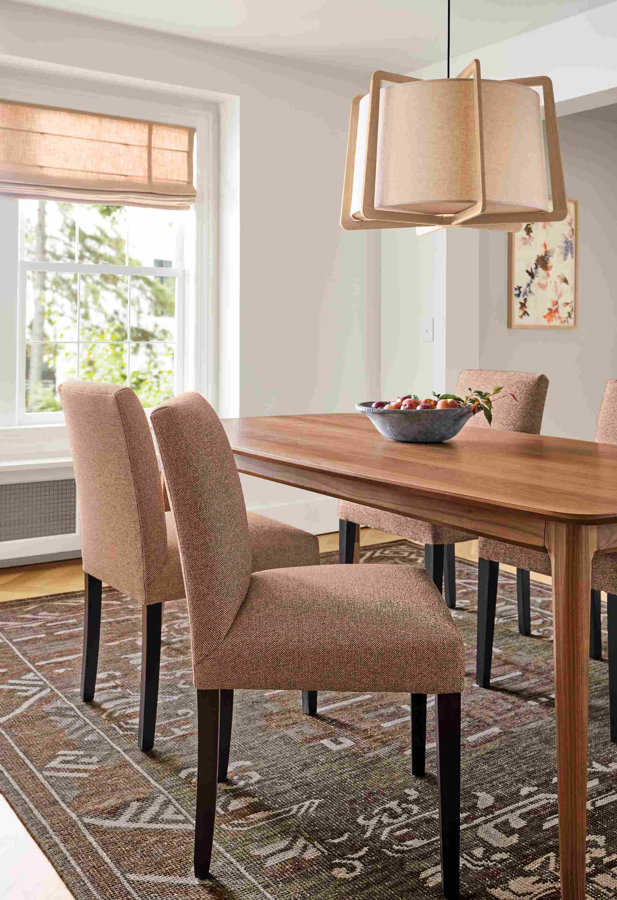 Dining room with Walcott table in walnut and Peyton side chairs in Tatum Clay with charcoal legs.